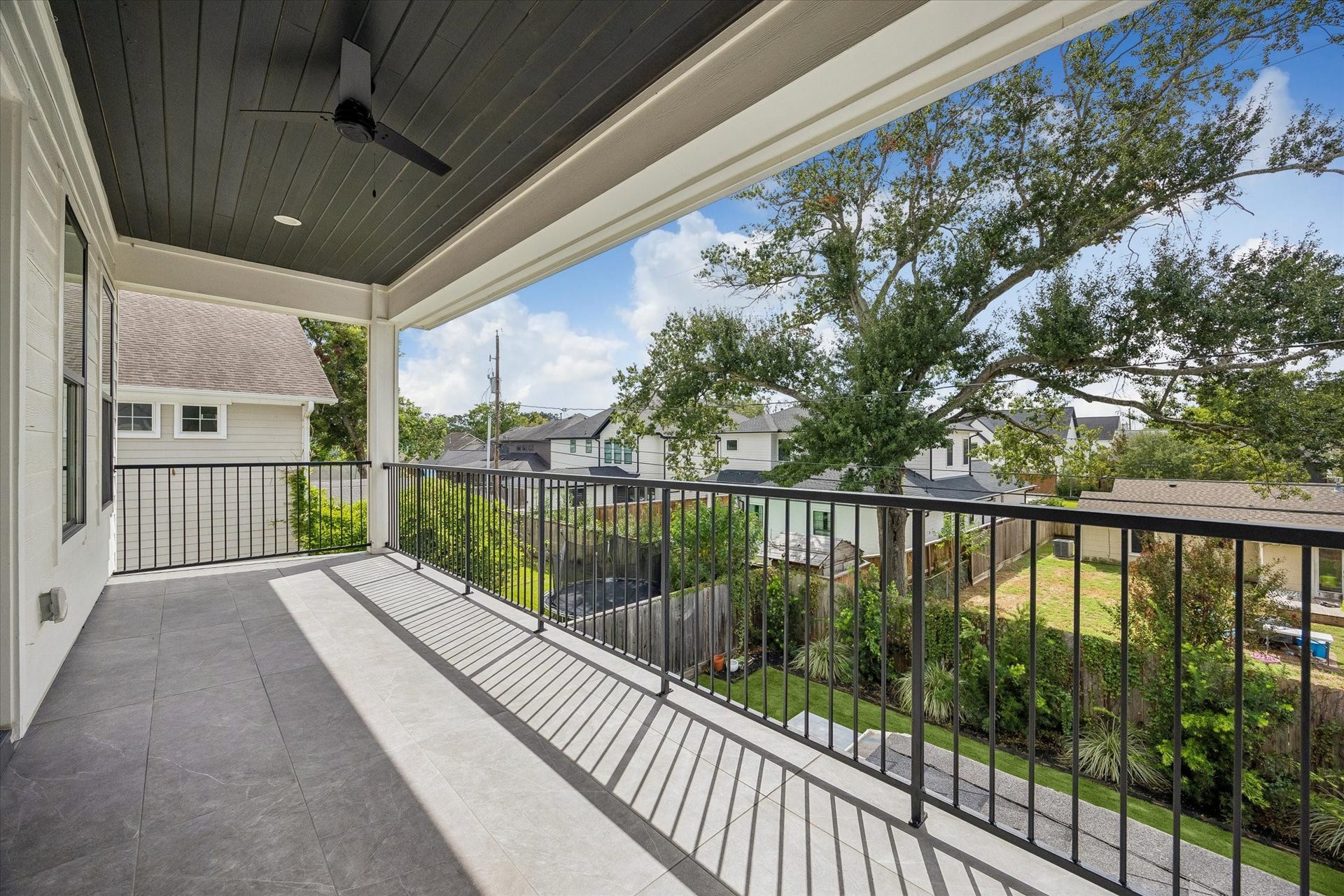An expansive covered balcony lures you from the primary and overlooks the serene pool.