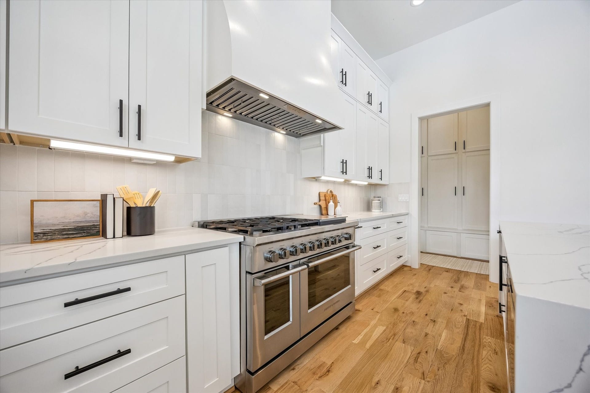 An elegant custom hood vent serves as a stunning focal point in the chefs kitchen, adding a refined touch to the sophisticated design