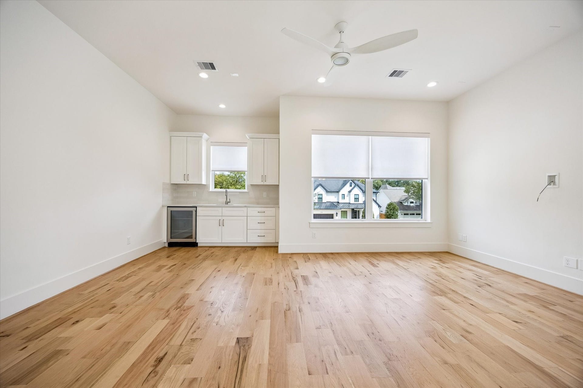 The ultimate gathering space, this impressive game room is designed for entertaining friends and family, complete with a stylish wet bar and Hisense beverage refrigerator.