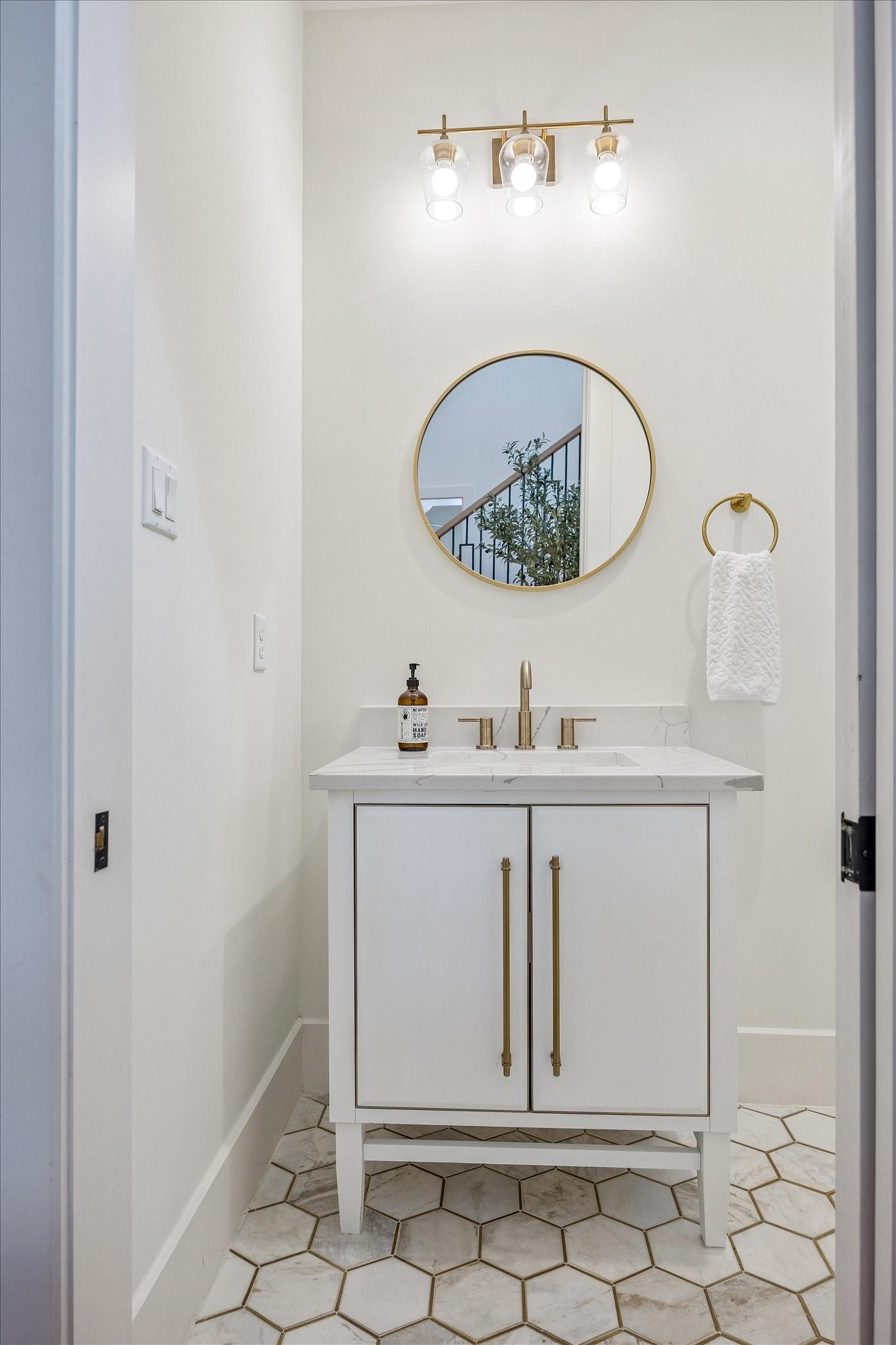 The powder bathroom is tucked away underneath the stairs.
