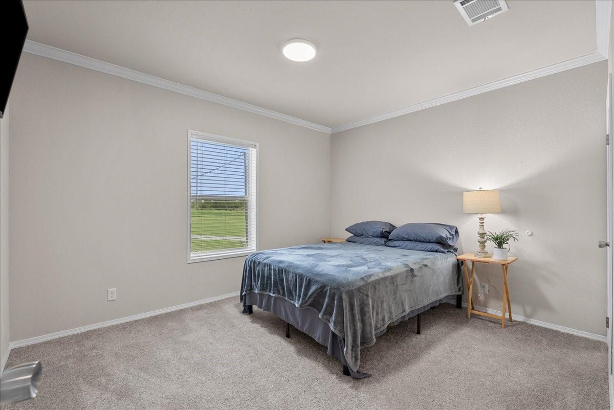 8710 Fm 646 Road S, Santa Fe, TX 77510 The third bedroom offers a lovely view of the backyard, creating a bright and peaceful space to enjoy