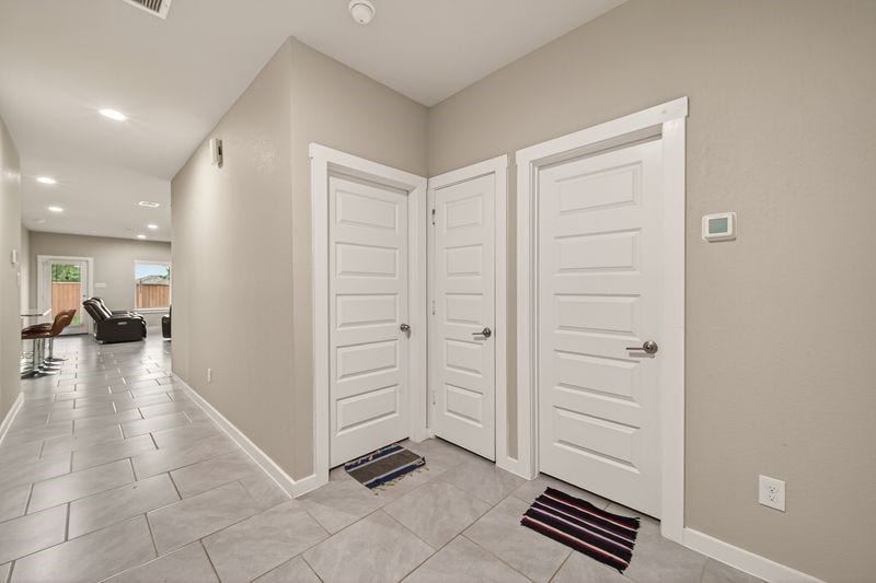 7523 Keystone Blossom Trail, Richmond, TX 77407 Extended view from the entry corridor revealing clean sightlines toward the main living area, with multiple doorways positioned for functional flow.