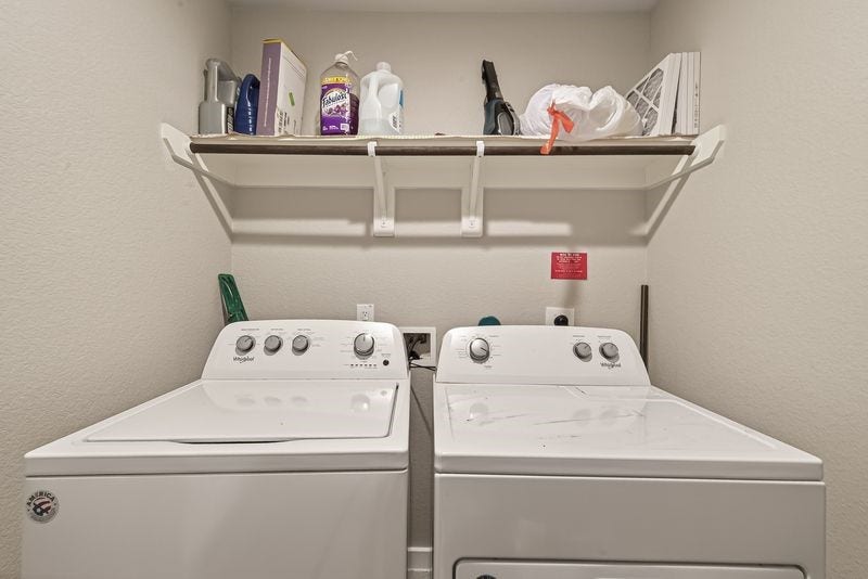 7523 Keystone Blossom Trail, Richmond, TX 77407 Dedicated utility room equipped with washer and dryer connections, complemented by an upper shelf for convenient storage.