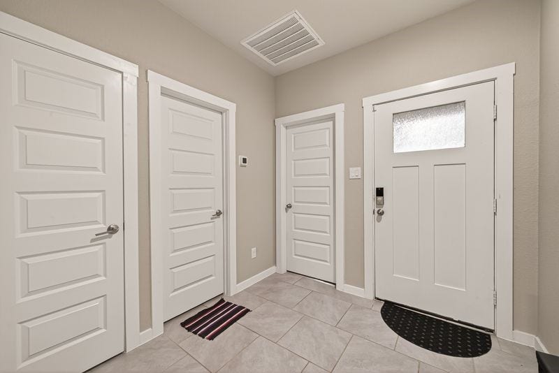 7523 Keystone Blossom Trail, Richmond, TX 77407 Welcoming foyer featuring clean tile flooring, multiple interior access points, and a defined entry layout that connects seamlessly to the homes main living areas.