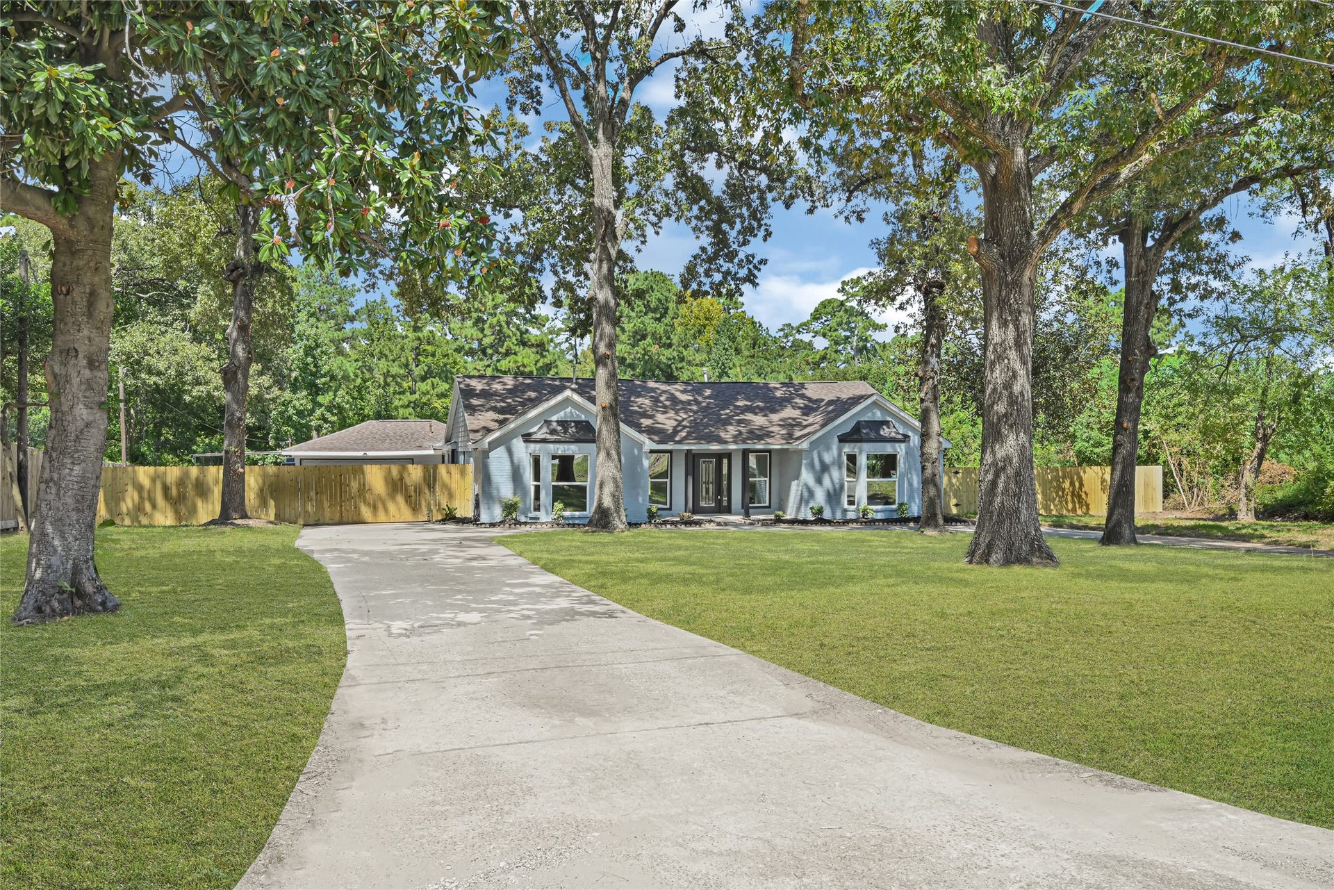 Beautifully landscaped driveway to the home with and abundance of mature trees.