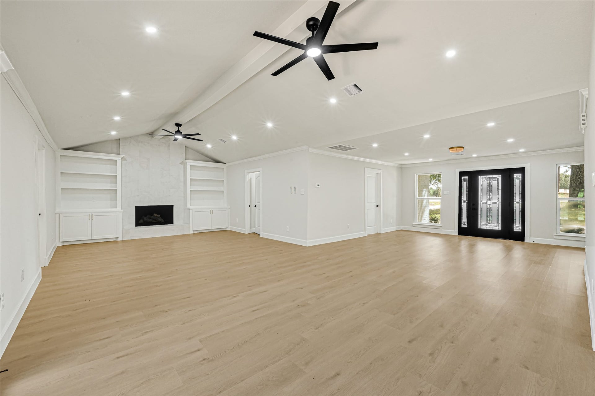 a view from the kitchen into the living room and entrance. A spacious open floor layout