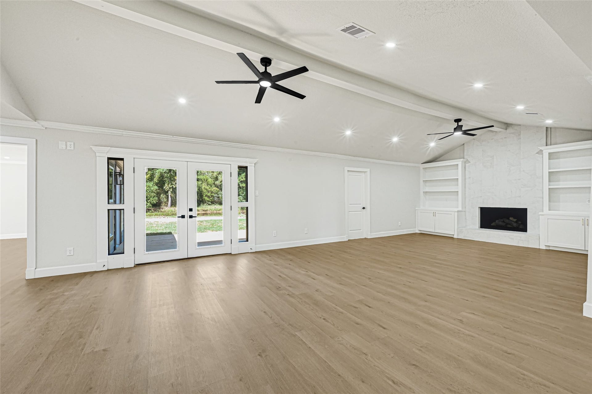 Beautiful living room with abundant natural light and a cozy fireplace