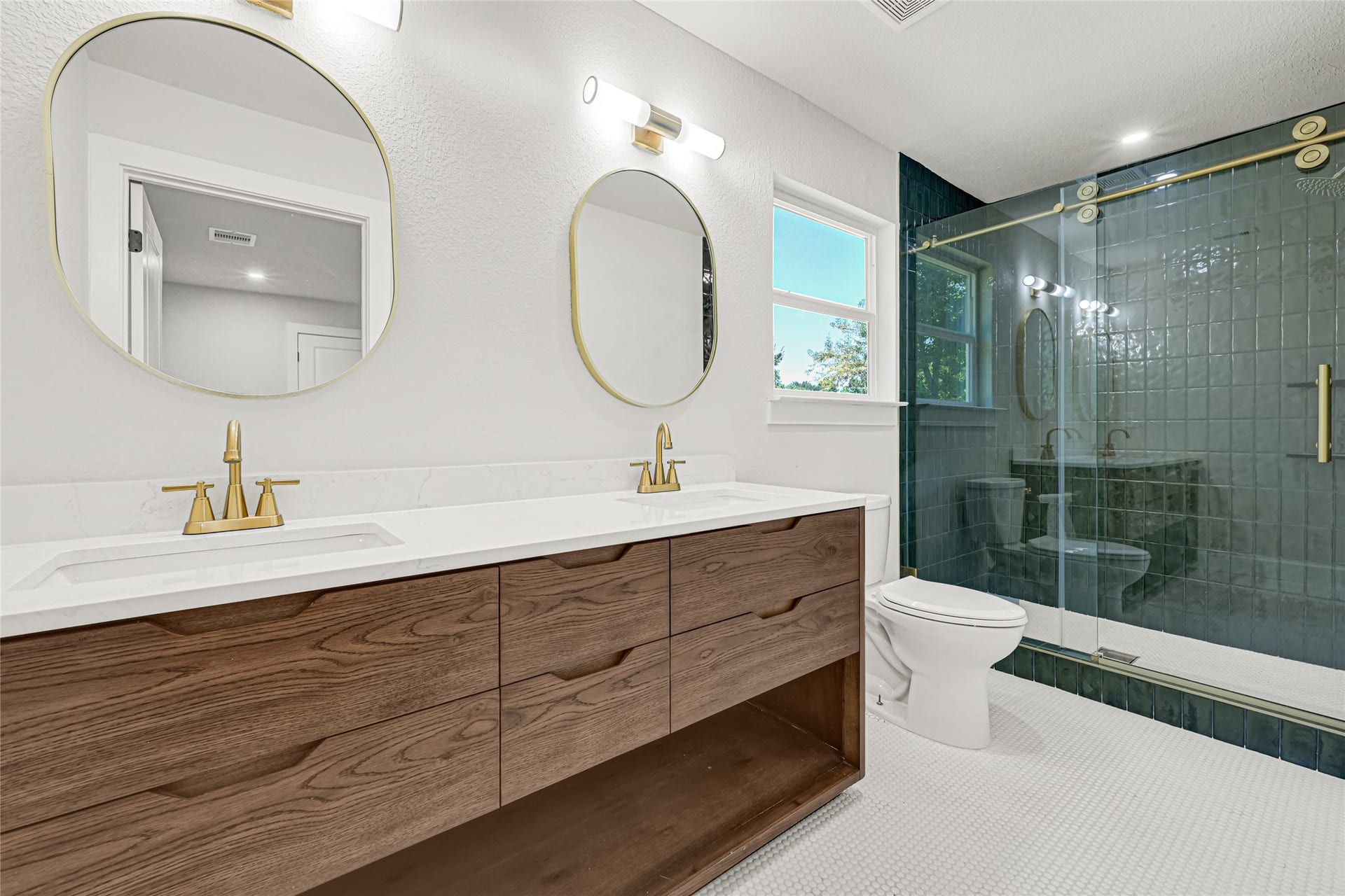 Spacious secondary bathroom with double sinks and a large shower