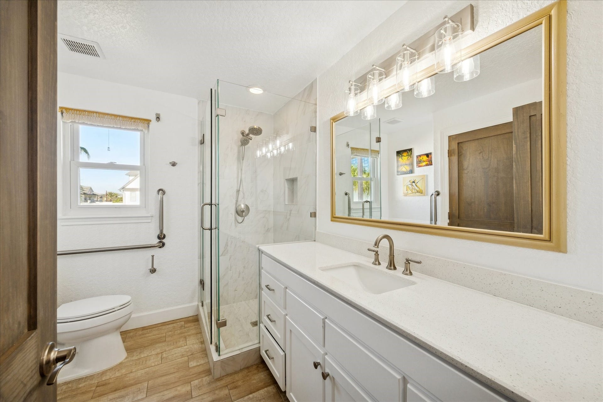 107 Bamaku Bend, Tiki Island, TX 77554 This beautifully updated first-floor bath features a long vanity, extra counter space and a glass-enclosed shower, creating a fresh, modern setting for family and guests.