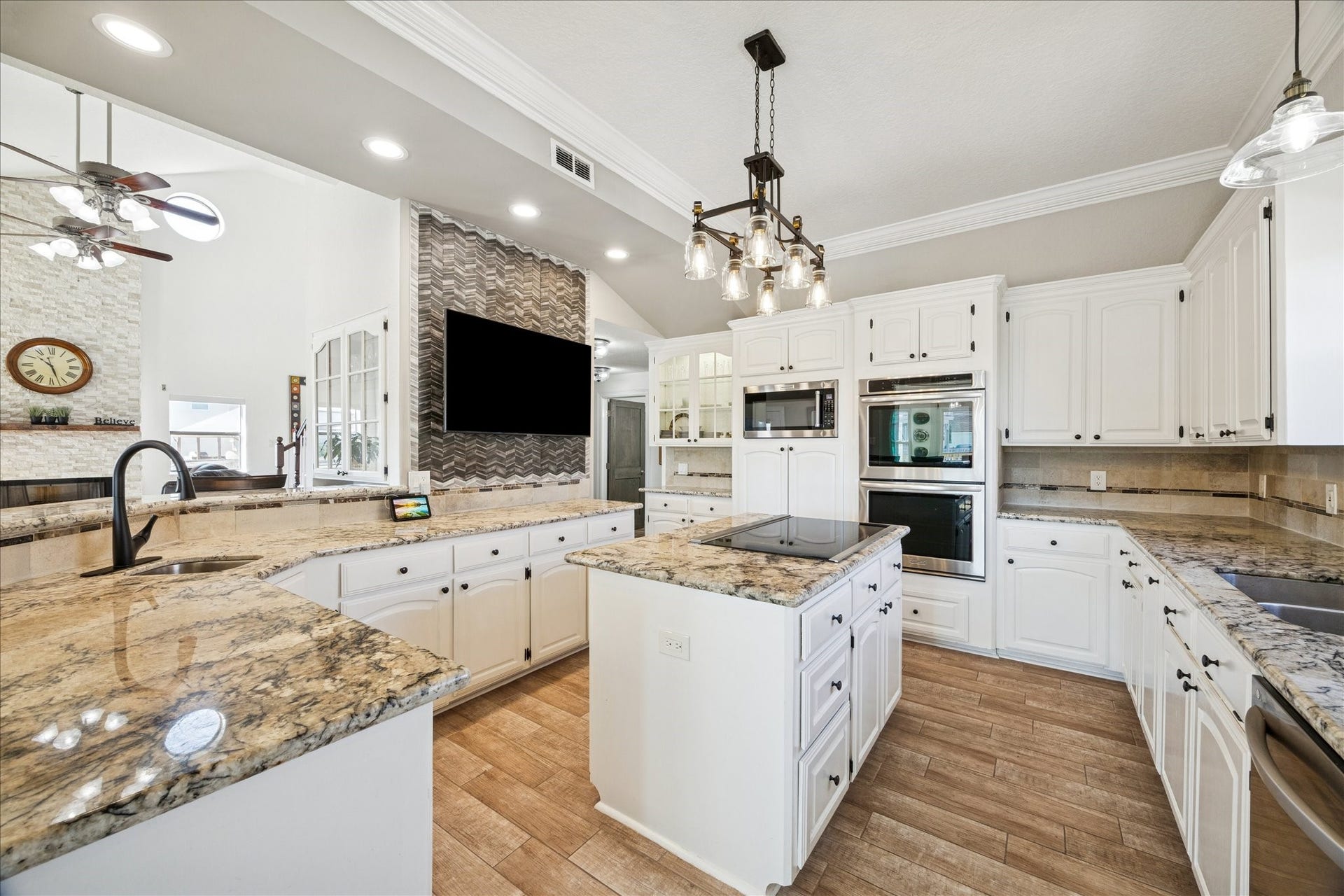 107 Bamaku Bend, Tiki Island, TX 77554 Bright and inviting, with a custom accent wall that draws the eye and gives the kitchen its own sense of style.