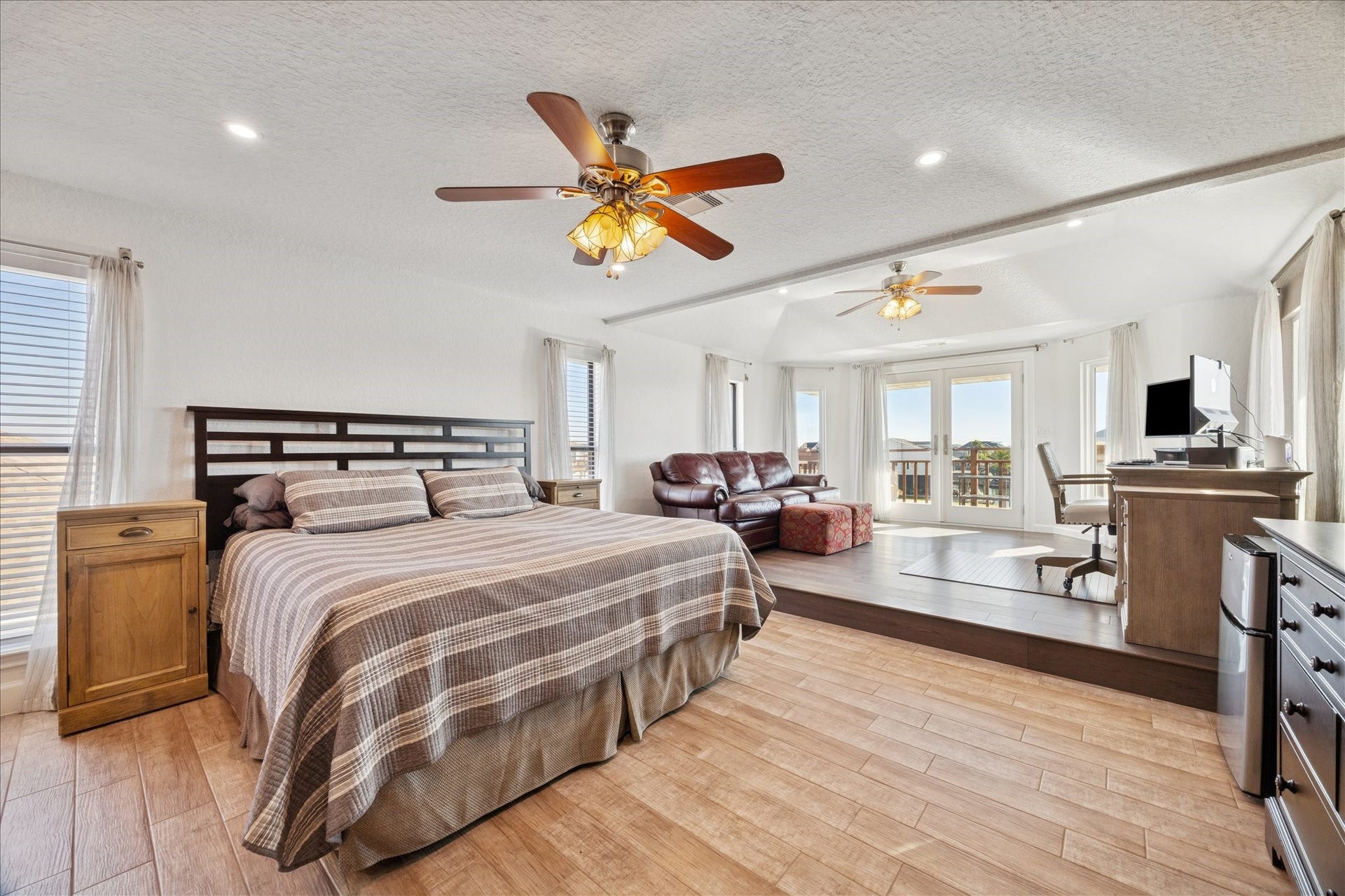 107 Bamaku Bend, Tiki Island, TX 77554 The primary bedroom delivers an immediate "wow" factor with its impressive scale and three-sided water views. For the current owners, this one-of-kind suite was the icing on the cake that ultimately sealed their decision to make this their home, and its lived up to every expectation.