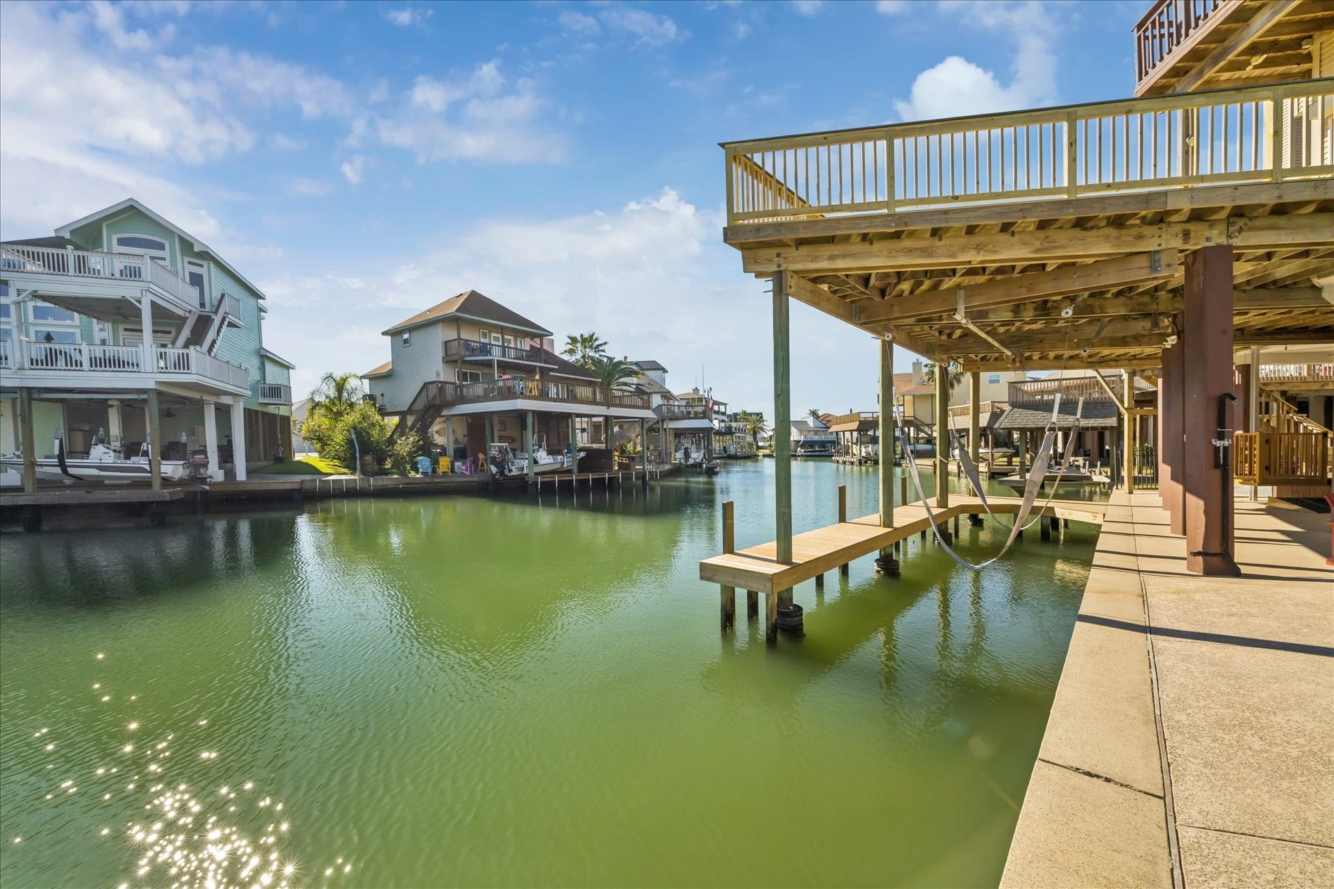 107 Bamaku Bend, Tiki Island, TX 77554 89 feet of deep waterfront supported by a concrete bulkhead provides room for multiple people to fish from the pier/dock or bulkhead. The covered boat slip and advantageous canal location provide exceptionally easy-in, easy-out access.