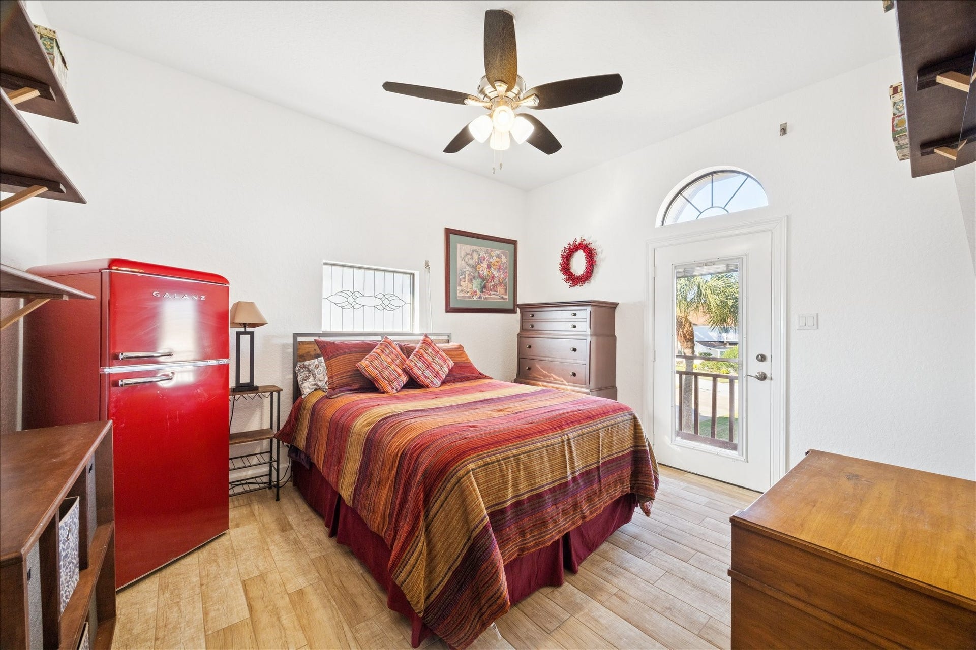 107 Bamaku Bend, Tiki Island, TX 77554 This comfortable bedroom with a patterned-glass window, custom shelving and its own private balcony, giving guests or family their own place to step outside and unwind.