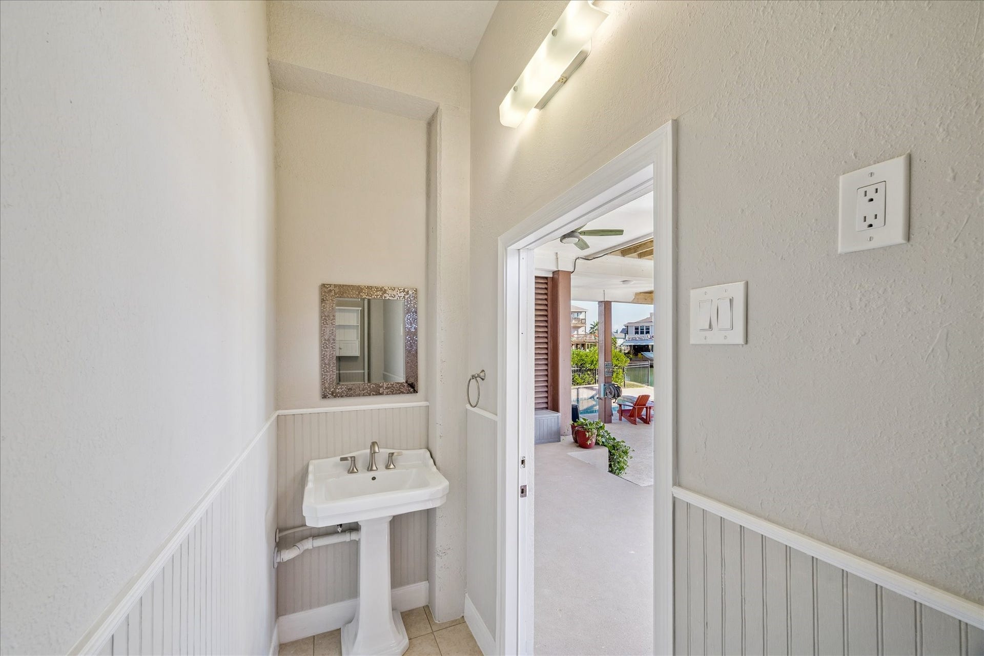 107 Bamaku Bend, Tiki Island, TX 77554 The pool-level bathroom keeps wet feet downstairs and adds convenience for swimmers, boaters and everyday outdoor living.