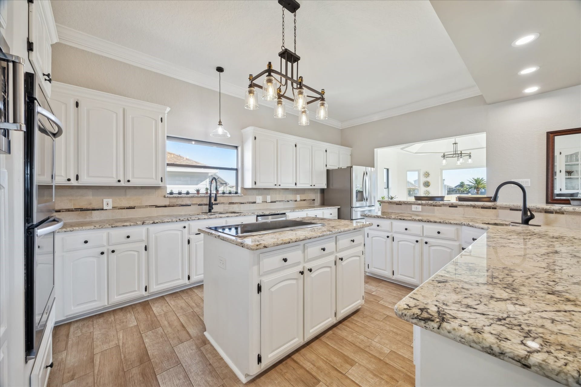 107 Bamaku Bend, Tiki Island, TX 77554 Spacious and thoughtfully laid out, this kitchen pairs generous counter space and storage with a large island, making cooking and daily living feel easy.