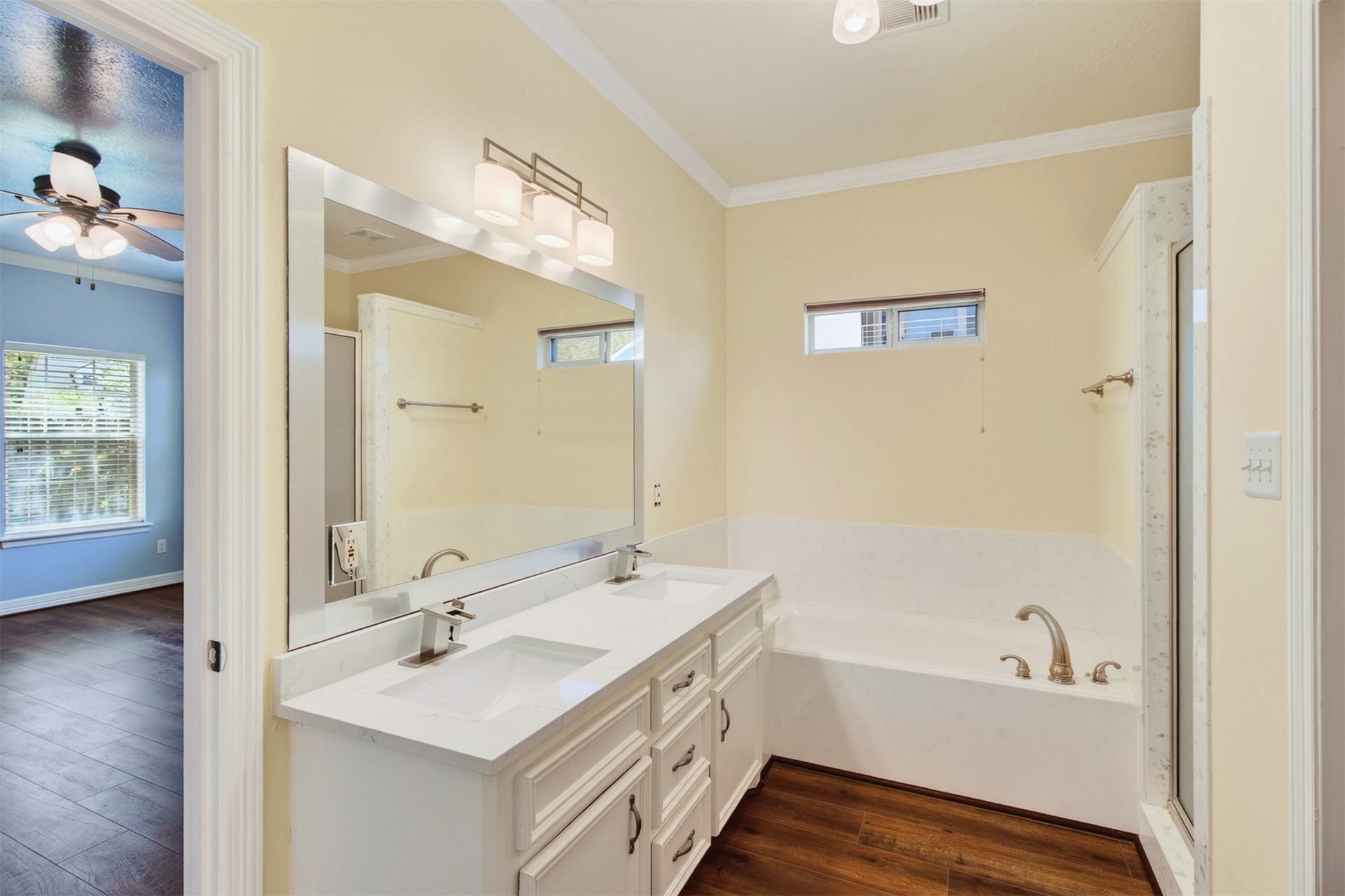 54 S Wind Drive, Montgomery, TX 77356 Primary bathroom with dual sinks, large luxury soaking tub with shower to the right.