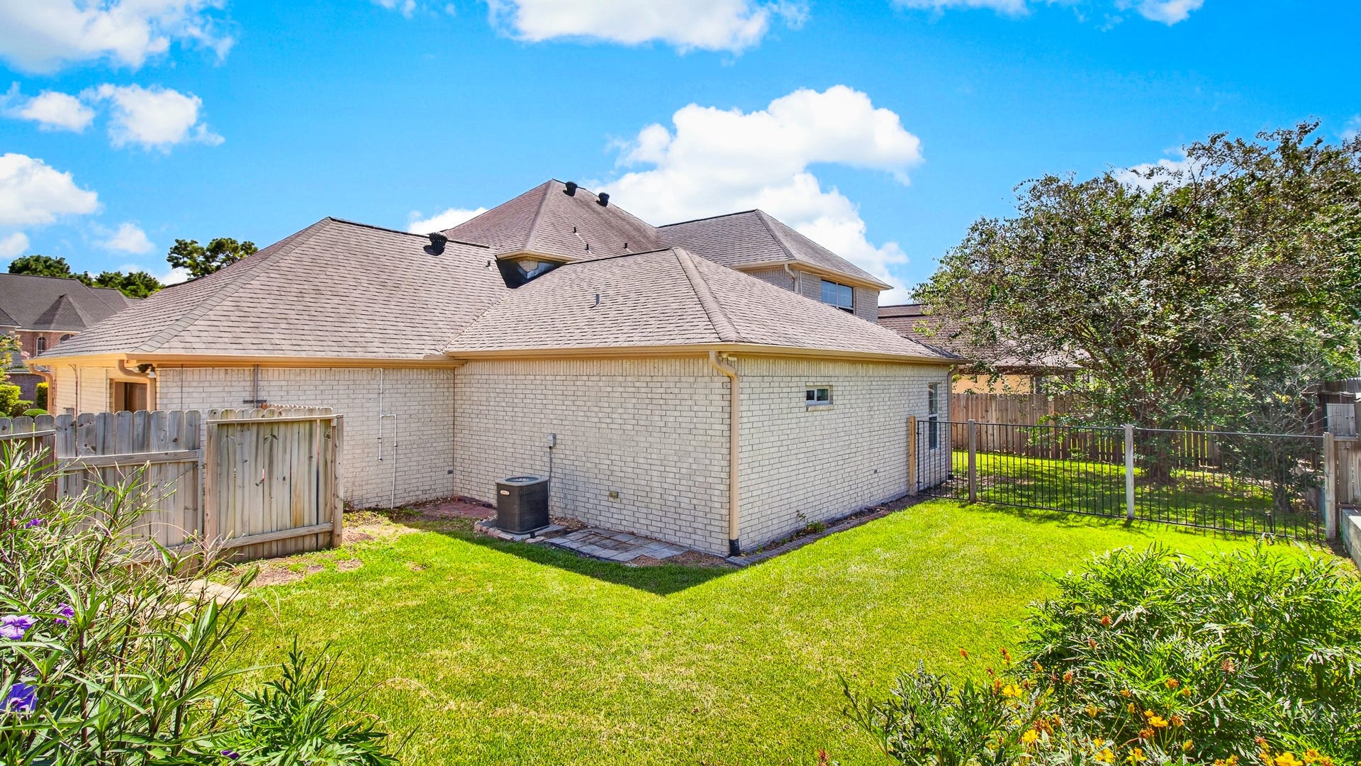 54 S Wind Drive, Montgomery, TX 77356 Nicely sized fenced backyard, split by wooden and metal fence with gate.