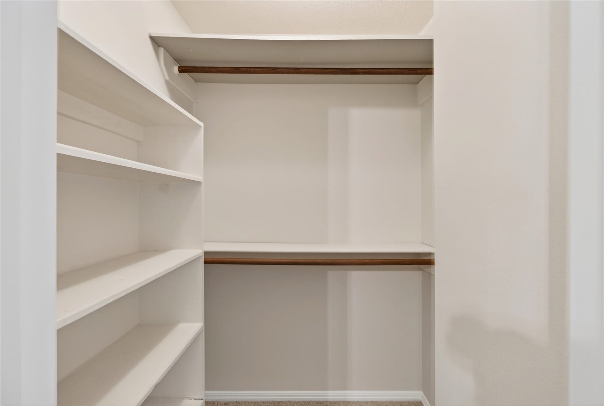 54 S Wind Drive, Montgomery, TX 77356 This is the primary closet in the upstairs bedroom off the primary bath. Lots of storage and shelving.
