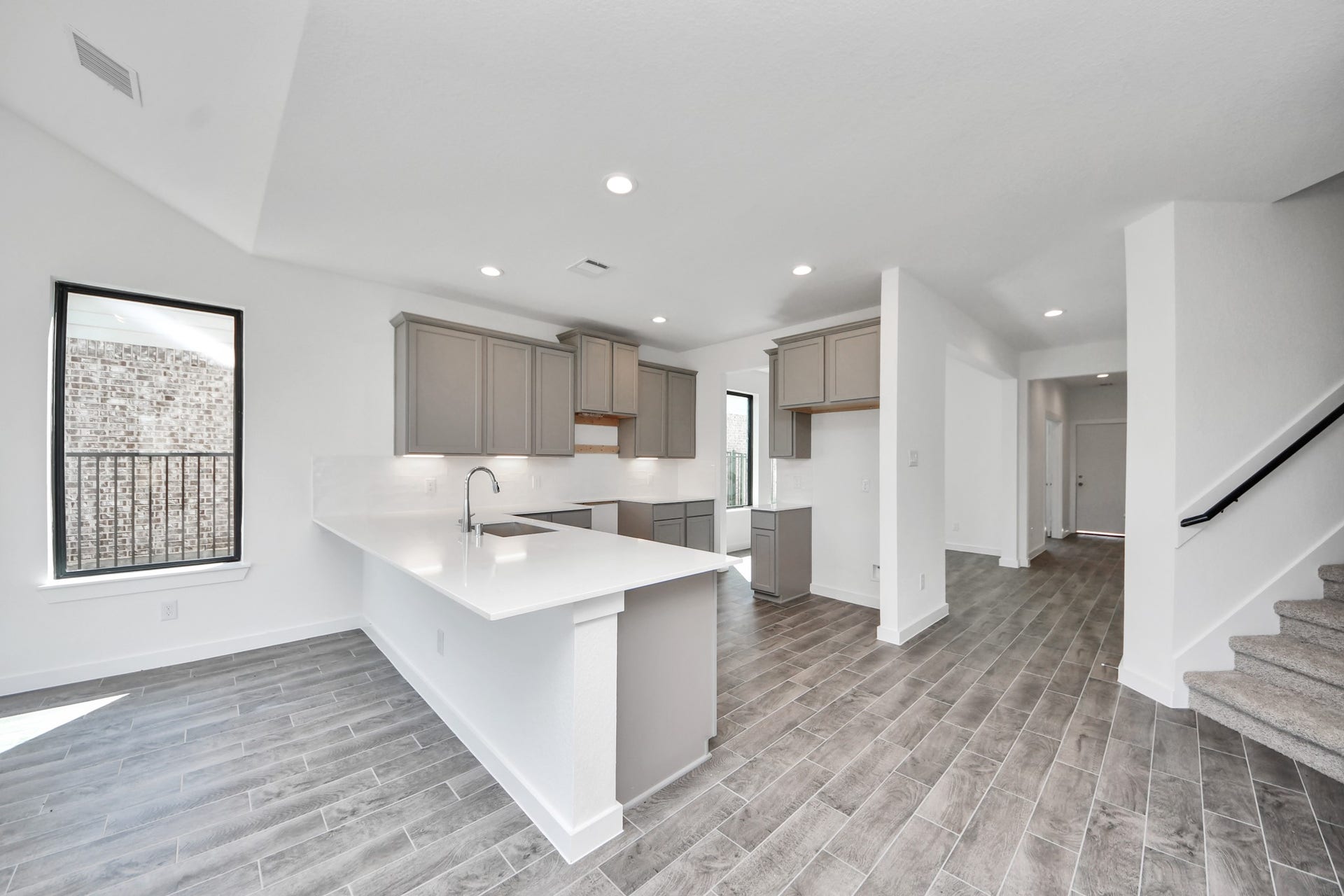 The kitchen is a culinary haven, featuring granite countertops, a tile backsplash, stainless steel appliances, 42 upper cabinets, and undercabinet lighting. Sample photo of completed home with similar floor plan. Actual colors and selections may vary.