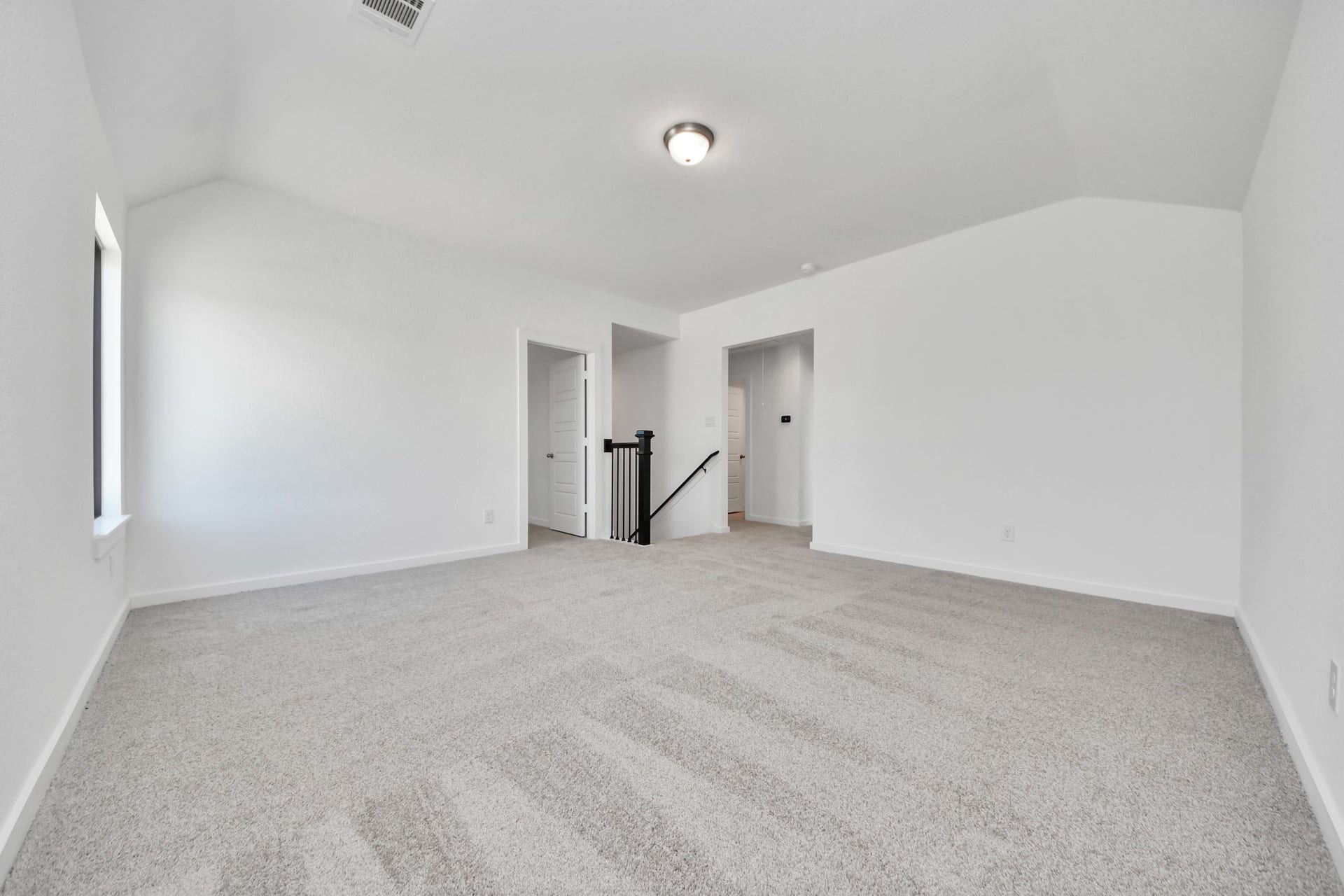 Discover a haven of leisure in this fantastic game room! Whether you're seeking a casual hangout or an adult gaming retreat, this space has it all. Enjoy the luxurious feel of plush carpet underfoot, the expansive ambiance of high ceilings, custom paint that adds a touch of personality, and windows that flood the room with refreshing natural light. Sample photo of completed home with similar floor plan. Actual colors and selections may vary.