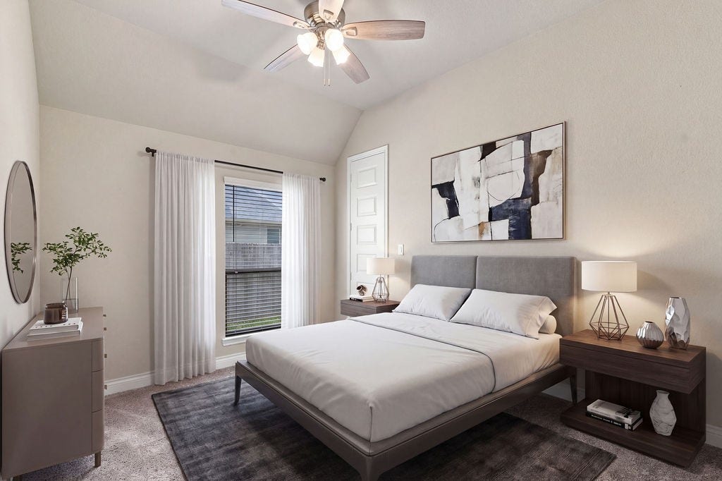 6914 Red Oak Drive, Katy, TX 77493 Inviting bedroom with a plush bed, contemporary art, and ample natural light, complemented by a sleek ceiling fan and elegant bedside tables.