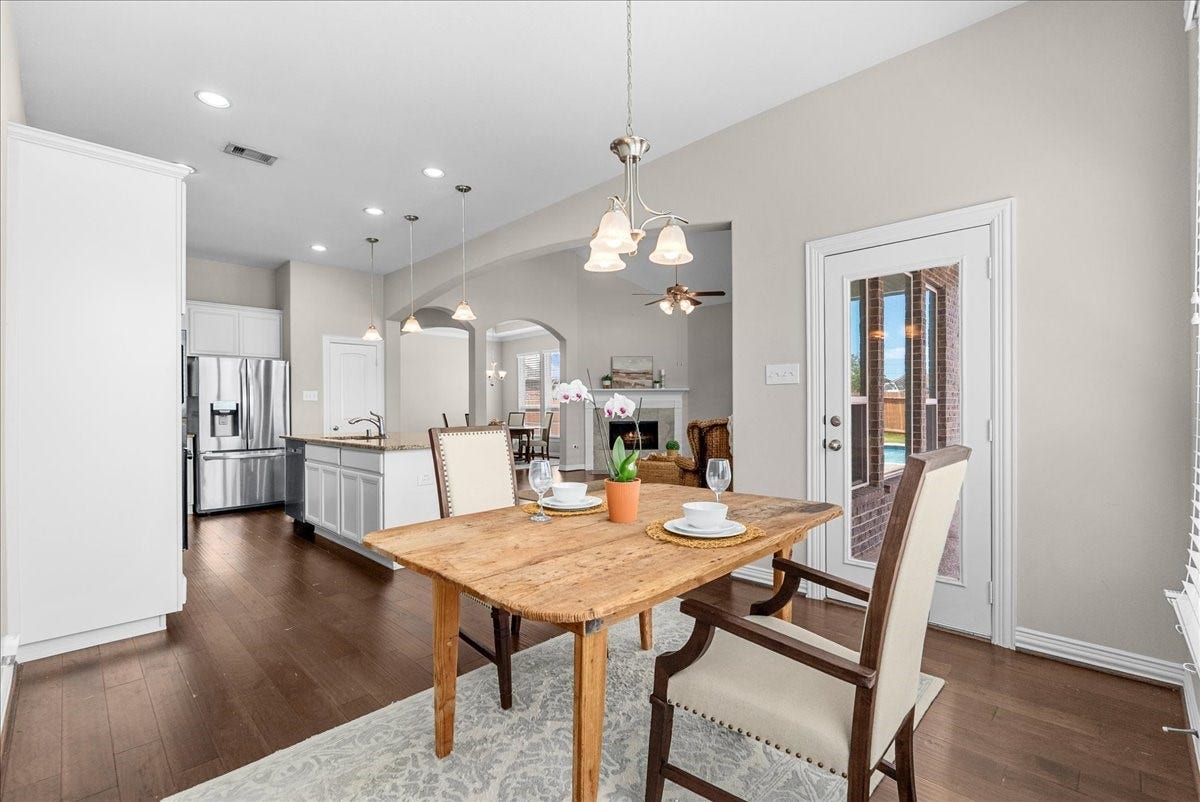 This breakfast area overlooks the kitchen and living room as well as having a great view of the pool area just to the right.