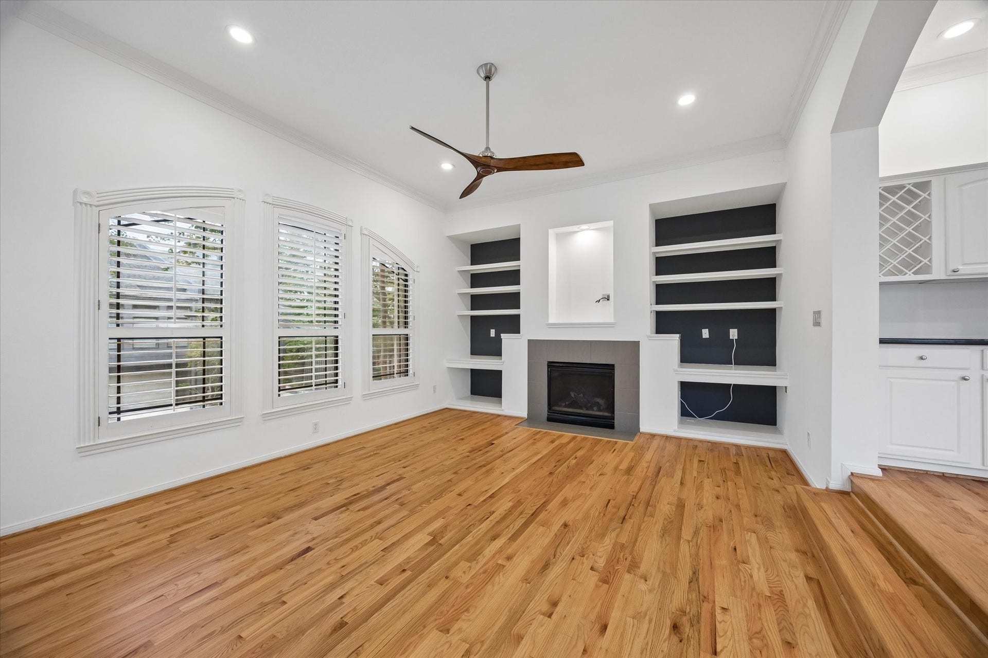 4123 Mcduffie Street, Houston, TX 77098 Living Area looking toward built ins and gas fireplace. Plantation shutters.
