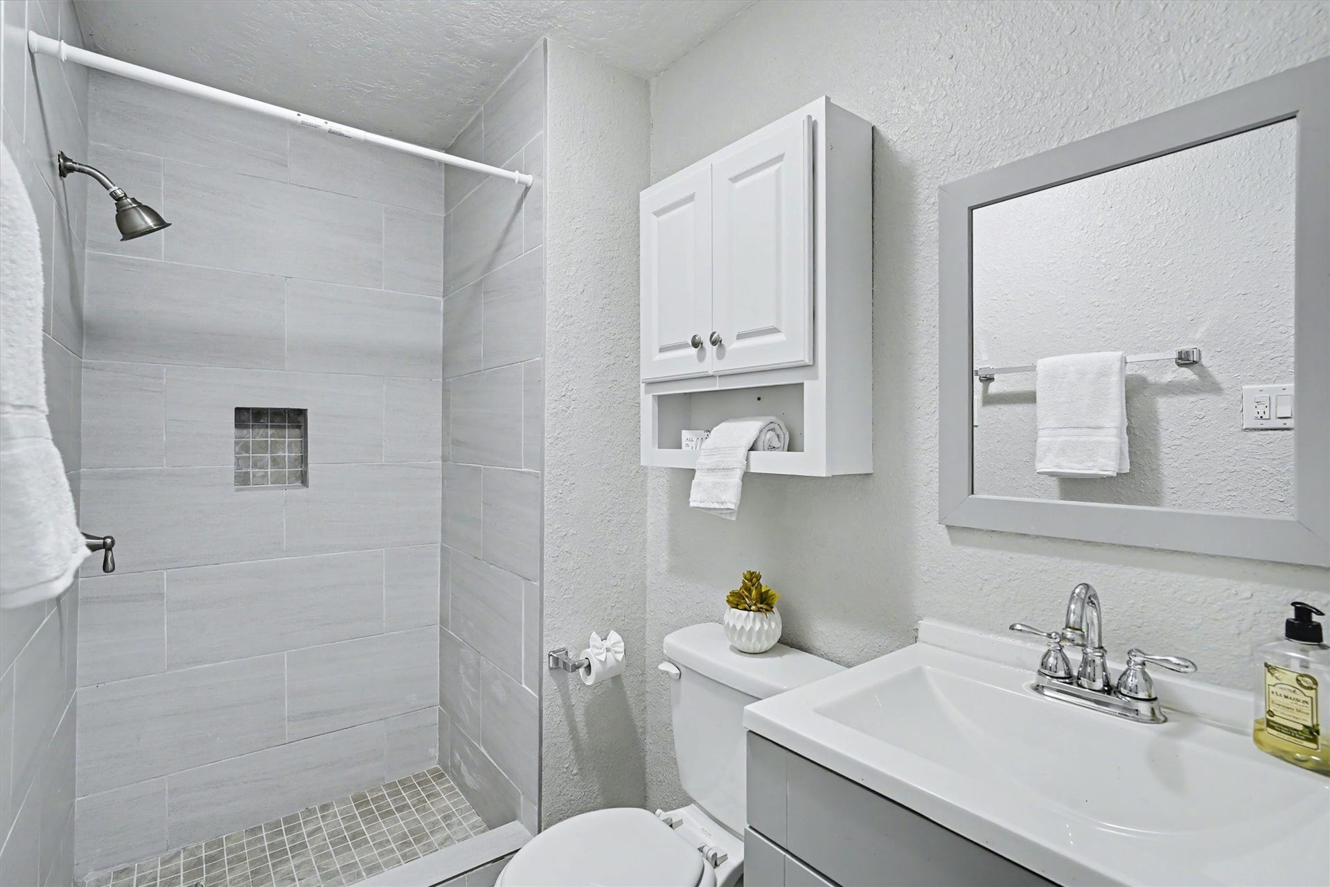 2523 7th Avenue N, Texas City, TX 77590 Updated secondary bathroom features a walk-in tiled shower, vanity and additional storage.