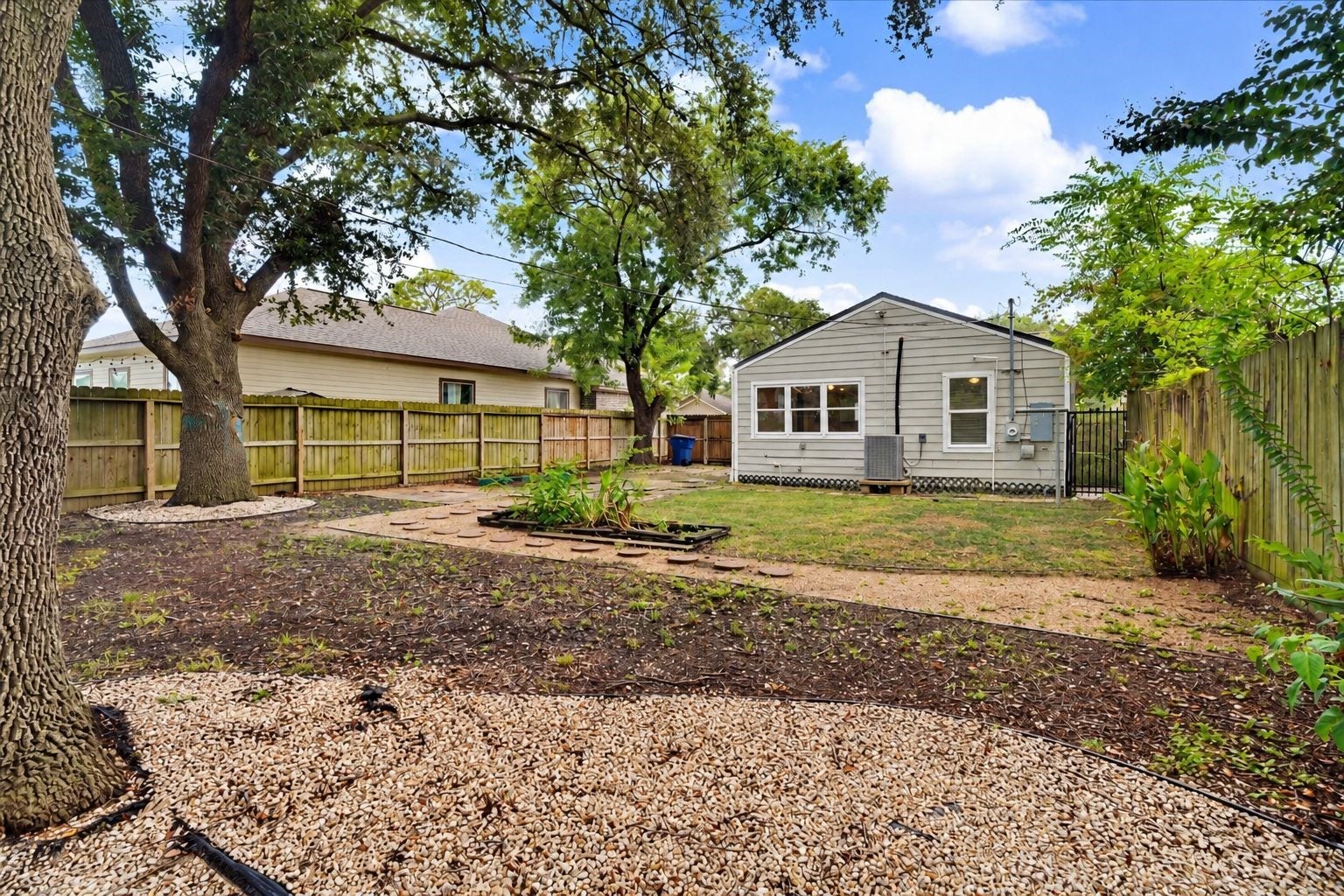 2523 7th Avenue N, Texas City, TX 77590 Spacious fenced backyard with mature shade trees and plenty of room to enjoy or personalize the outdoor space.