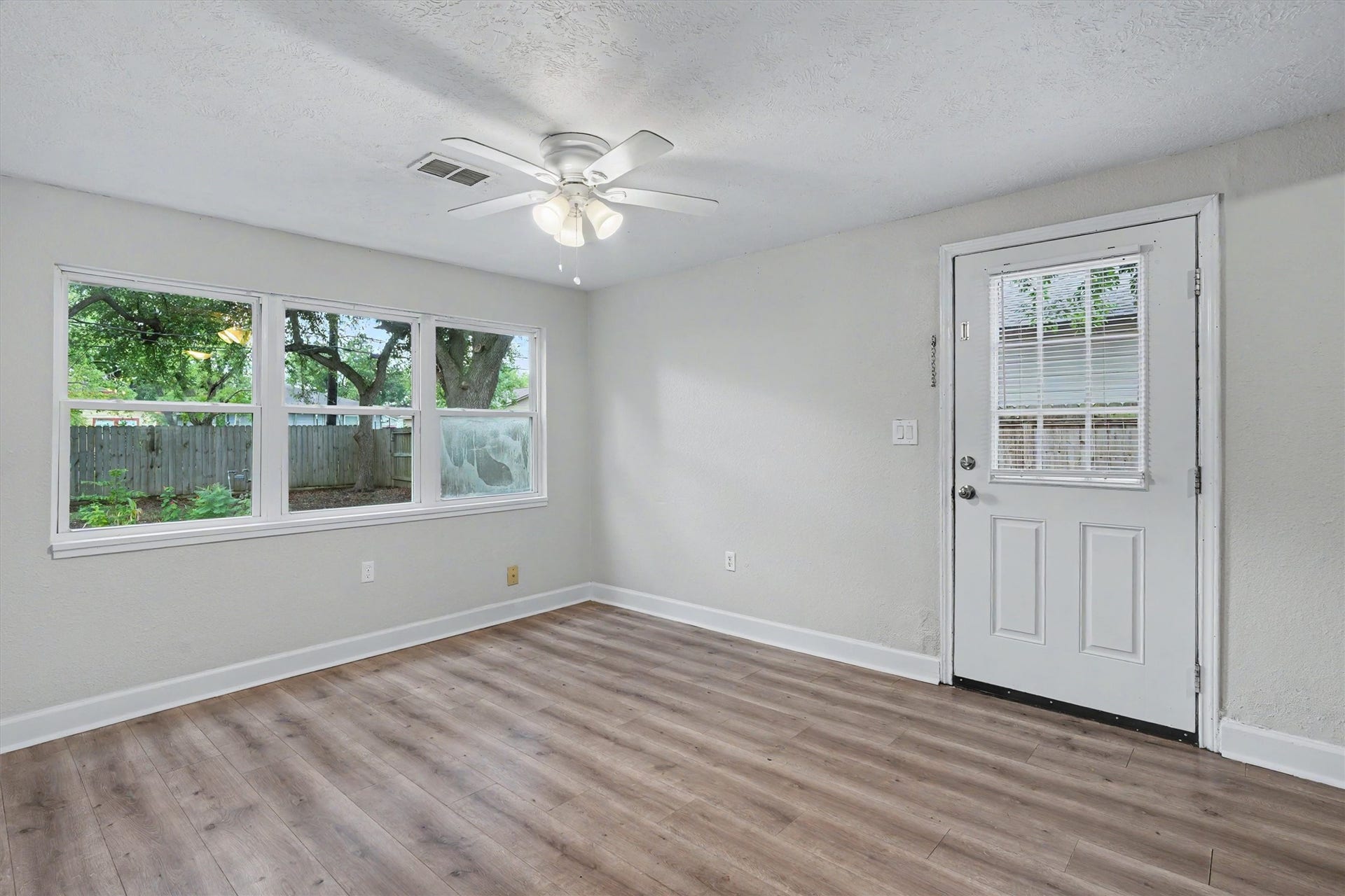2523 7th Avenue N, Texas City, TX 77590 Large windows bring natural light into the living area, with a back door providing convenient access to the yard.