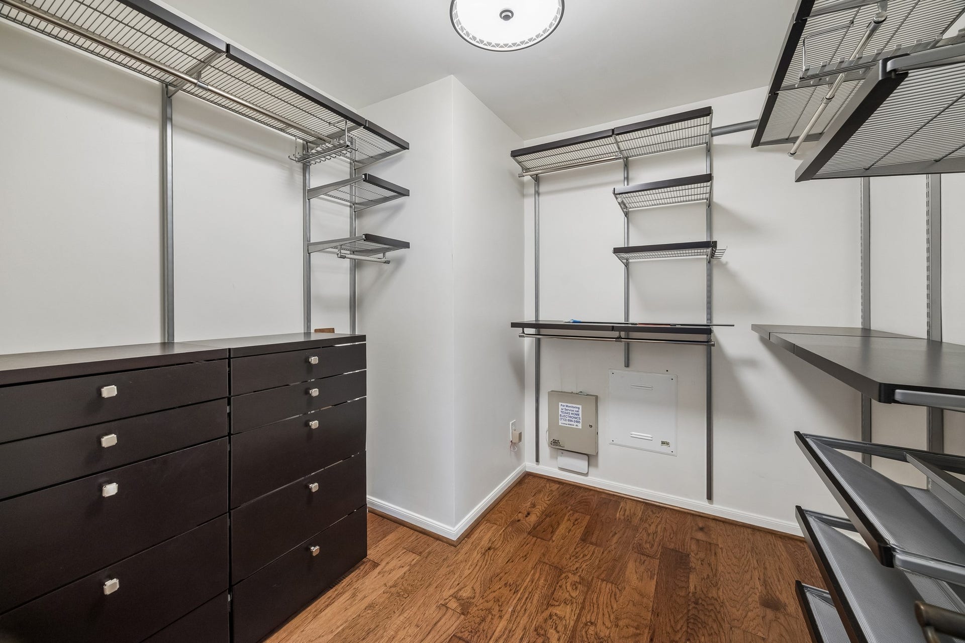 1439 Waverly Street, Houston, TX 77008 Second primary walk-in closet with custom built-in organization, including extensive hanging space, drawers, and open shelving.