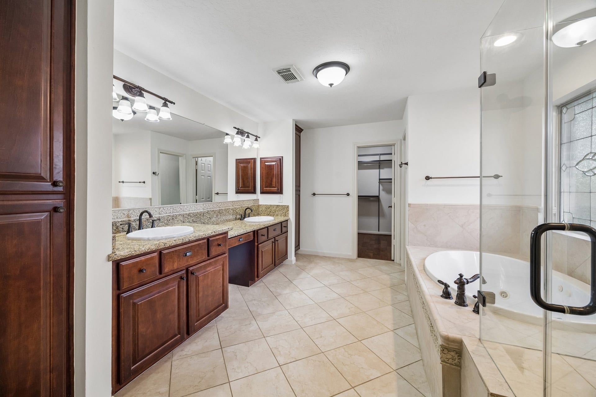1439 Waverly Street, Houston, TX 77008 Primary bath featuring dual vanities, an expansive countertop, abundant storage, and a spacious walk-in shower.