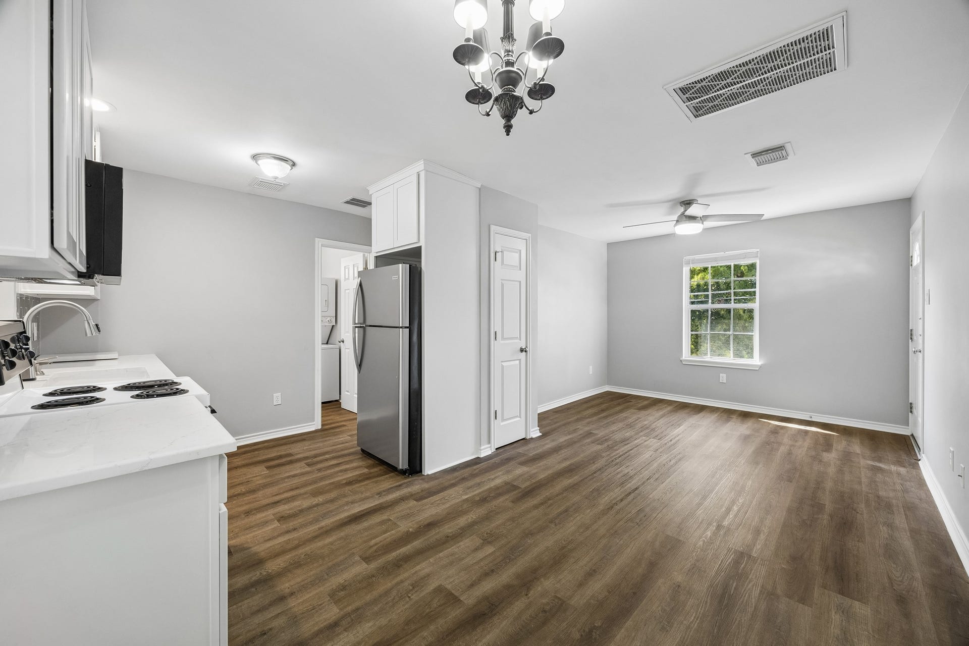 1439 Waverly Street, Houston, TX 77008 Detached garage apartment featuring engineered wood flooring, recessed lighting, and an open living area filled with natural light.