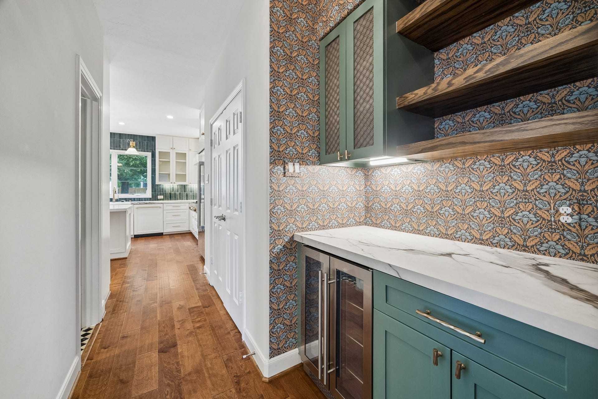 1439 Waverly Street, Houston, TX 77008 Custom dry bar between the kitchen and dining room, featuring a beverage refrigerator, open shelving, and a stylish backsplash. A spacious pantry provides additional storage nearby.