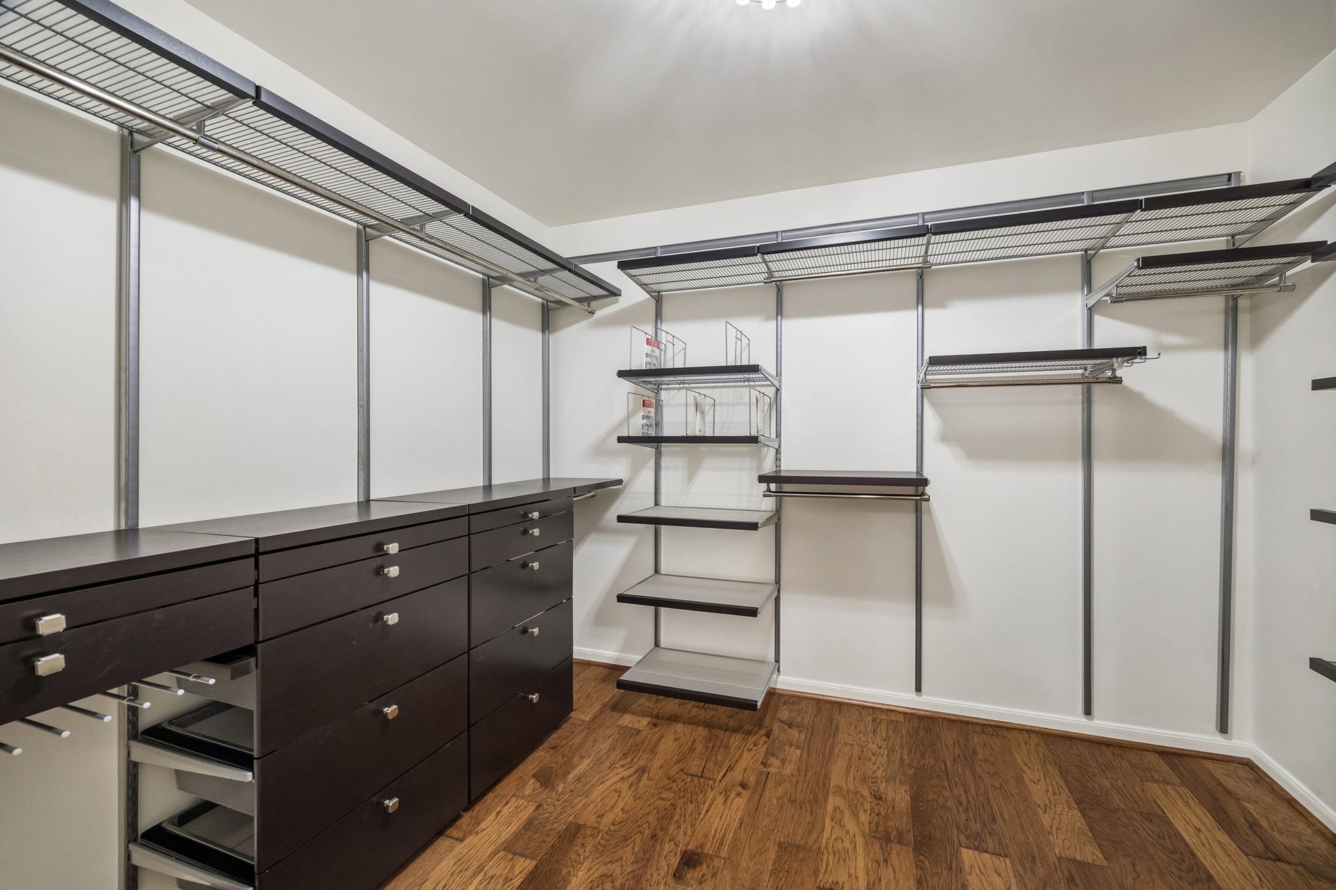 1439 Waverly Street, Houston, TX 77008 One of two primary walk-in closets, featuring an extensive custom organization system with open shelving, hanging space, and drawers.