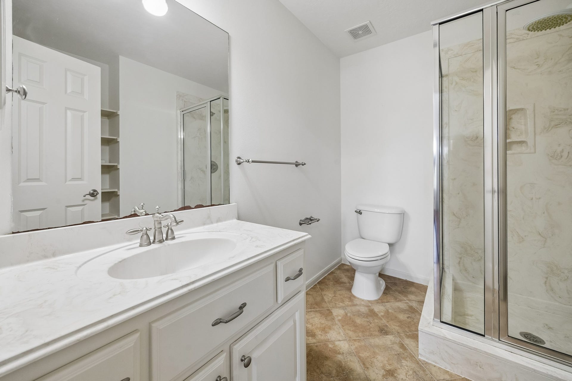 1439 Waverly Street, Houston, TX 77008 En suite bath with a dual-sink vanity, generous counter space, and a spacious walk-in shower with contemporary tile finishes.