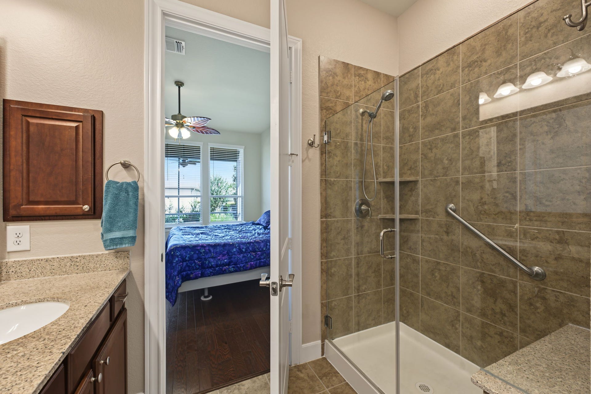 Primary bathroom features a shower with a bench