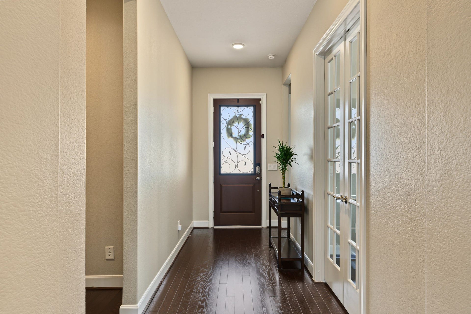 French doors on the right lead to a private home office/study.