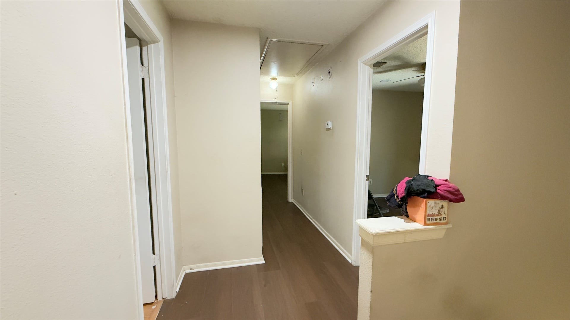 4119 King Cotton Lane, Missouri City, TX 77459 Inviting hallway with neutral tones, hardwood flooring, and multiple doorways leading to various rooms, creating a welcoming and functional space.