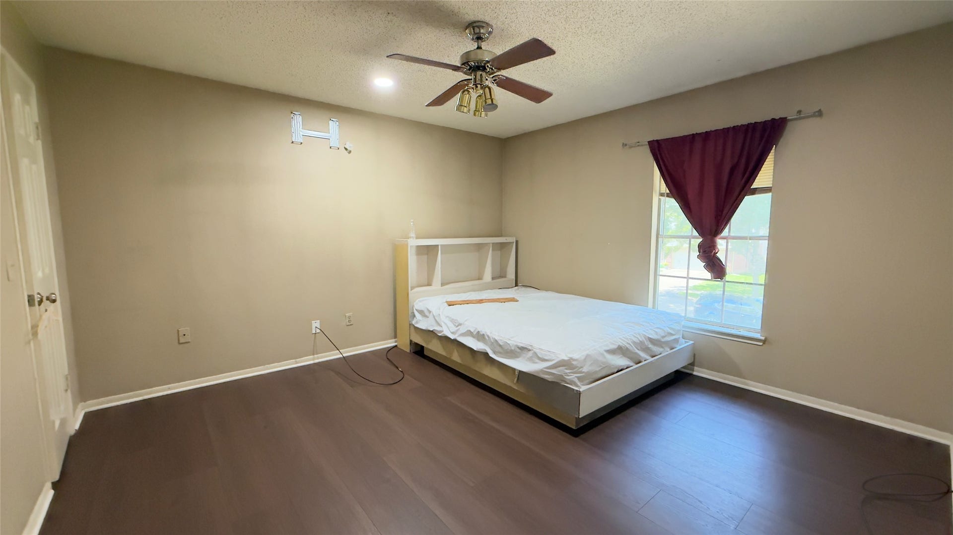 4119 King Cotton Lane, Missouri City, TX 77459 Spacious bedroom #2 with dark wood flooring, a ceiling fan, and a large window for natural light.