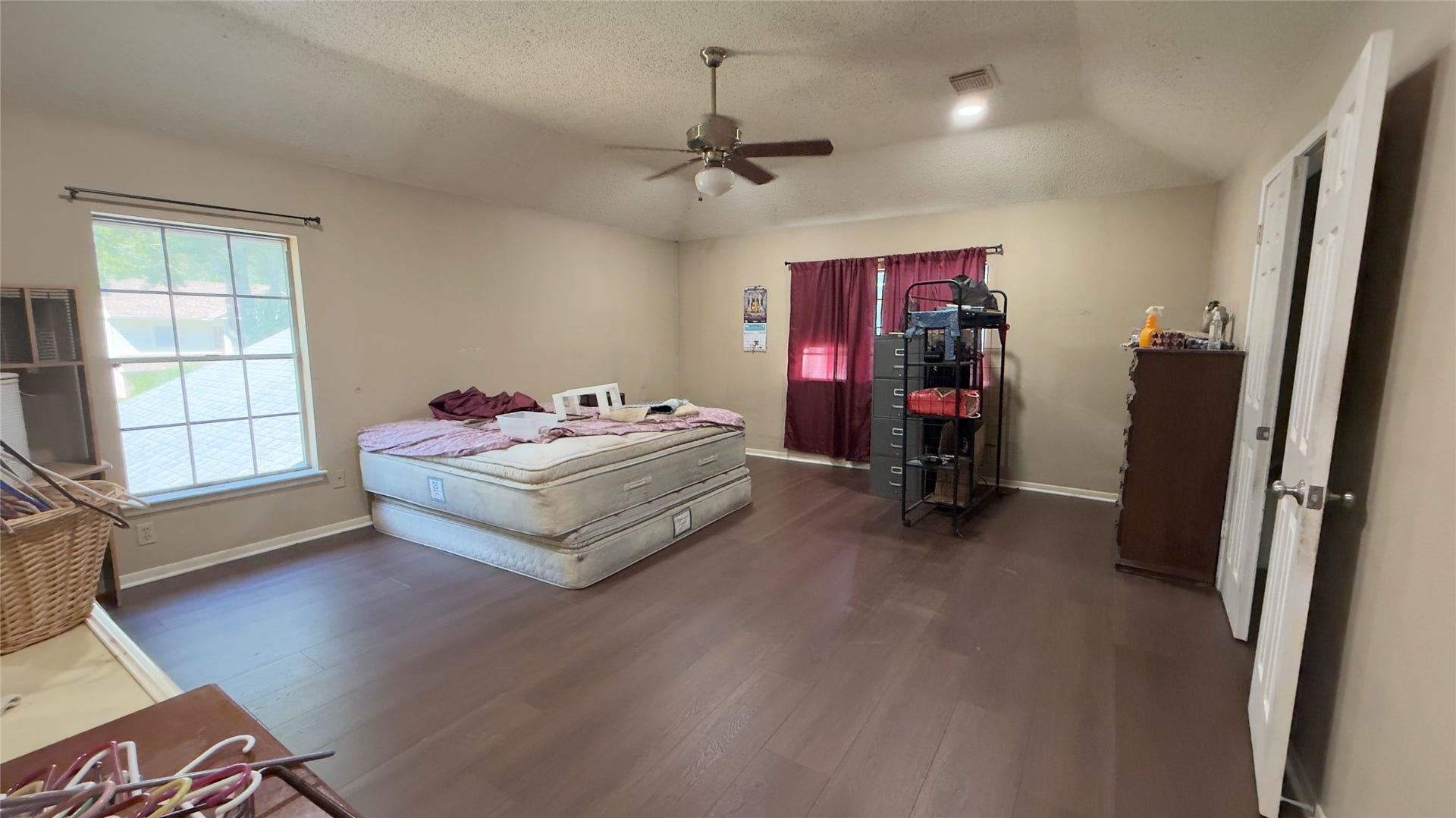 4119 King Cotton Lane, Missouri City, TX 77459 Spacious Master bedroom with high ceilings, large window for natural light, and wood flooring, perfect for creating a cozy retreat.