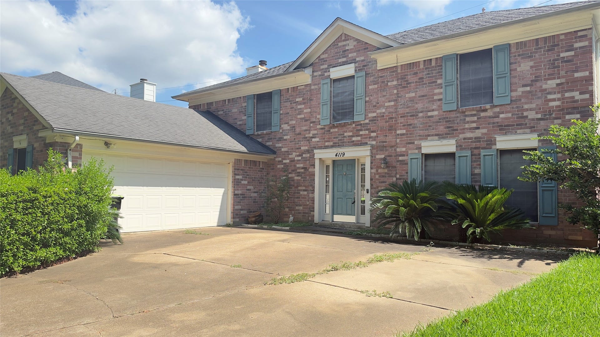 4119 King Cotton Lane, Missouri City, TX 77459 Charming two-story brick home with classic shutters, inviting entryway, and a spacious attached garage, perfect for family living.