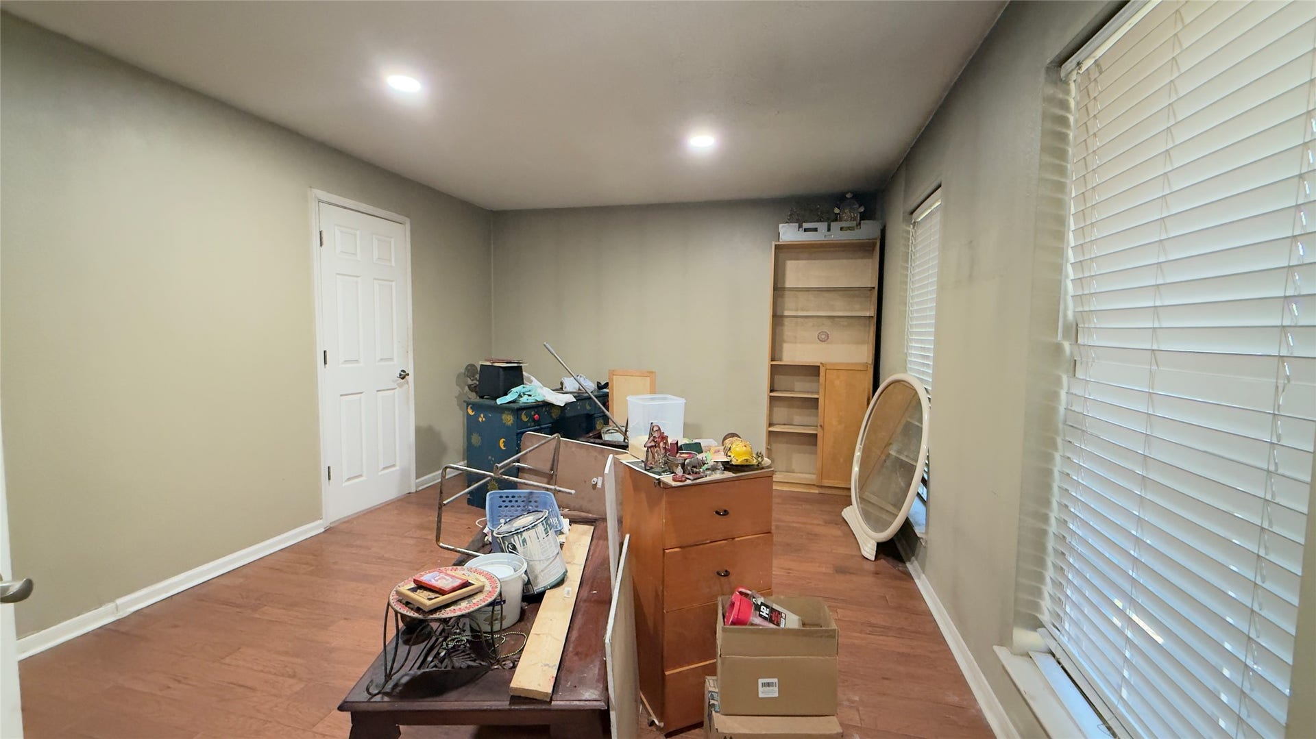 4119 King Cotton Lane, Missouri City, TX 77459 Spacious room with wood flooring, ample natural light from large windows, and versatile potential for customization.