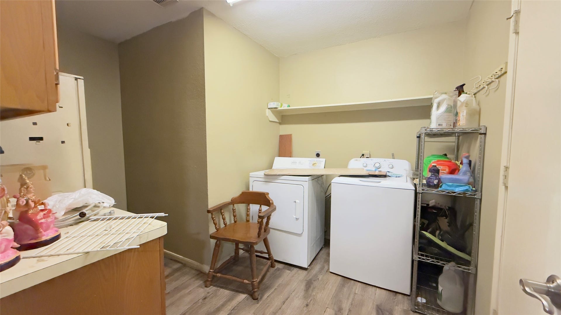 4119 King Cotton Lane, Missouri City, TX 77459 Convenient laundry room with washer and dryer, ample shelving for storage, and sleek laminate flooring.