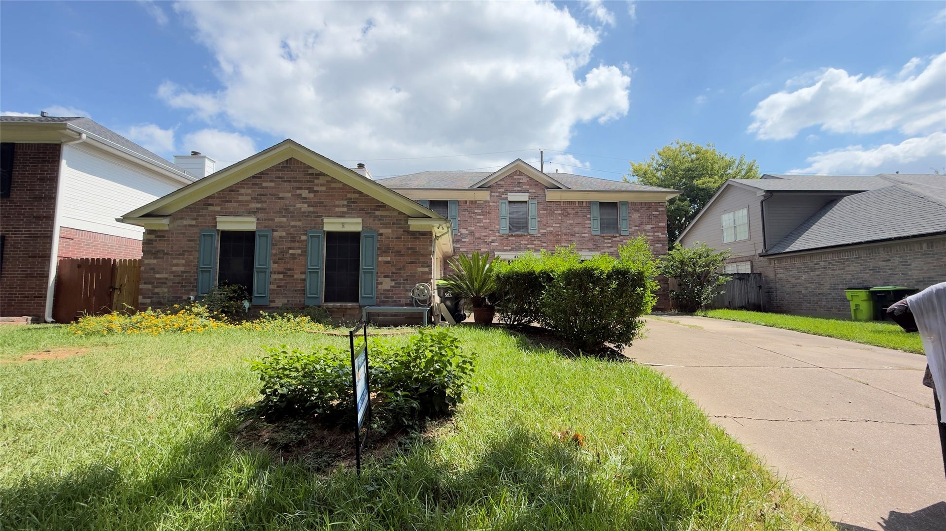 4119 King Cotton Lane, Missouri City, TX 77459 Charming brick home with a welcoming front yard and a spacious driveway, nestled in a serene neighborhood.