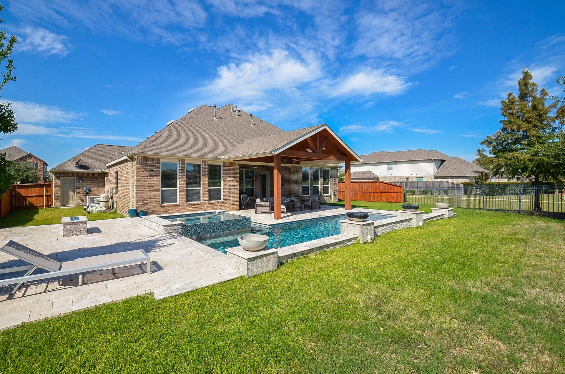 18438 Panton Terrace Lane, Cypress, TX 77429 Stunning view of the home's exterior, featuring a beautiful covered patio and an inviting, resort-style pool!