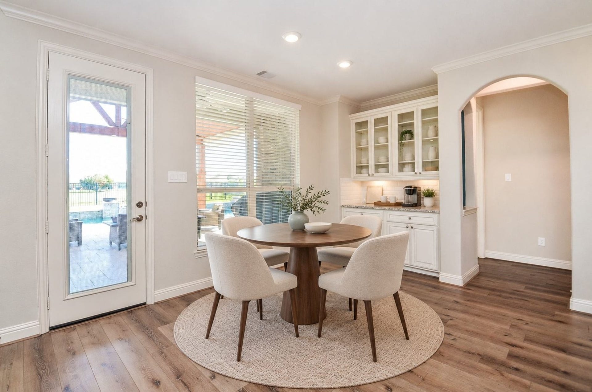 18438 Panton Terrace Lane, Cypress, TX 77429 Spacious breakfast room featuring custom built-in cabinetry with elegant glass-front displays, perfect for showcasing your fine china and dinnerware!