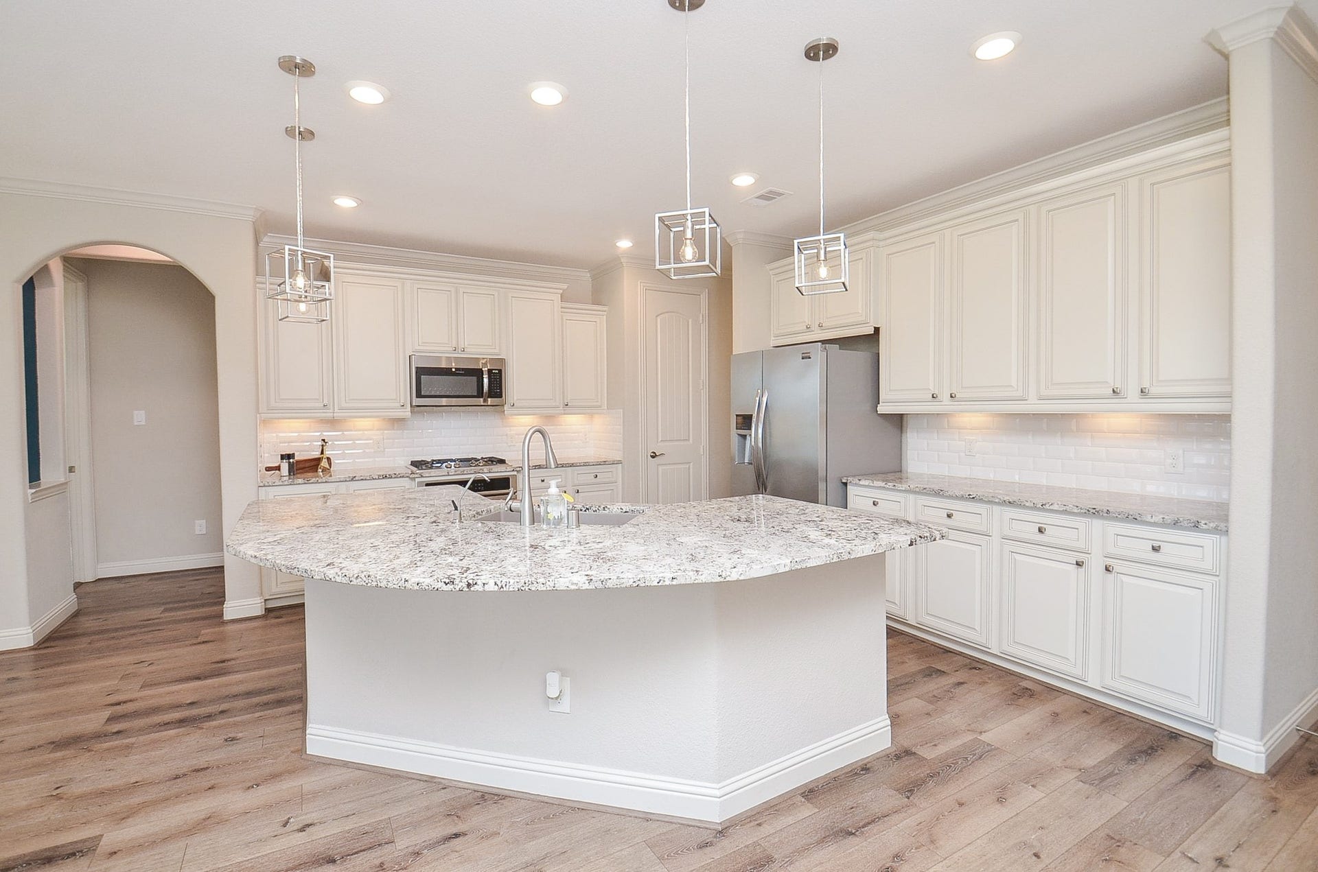 18438 Panton Terrace Lane, Cypress, TX 77429 Stunning kitchen featuring a large breakfast bar and an open-concept layout that flows seamlessly into the living room!