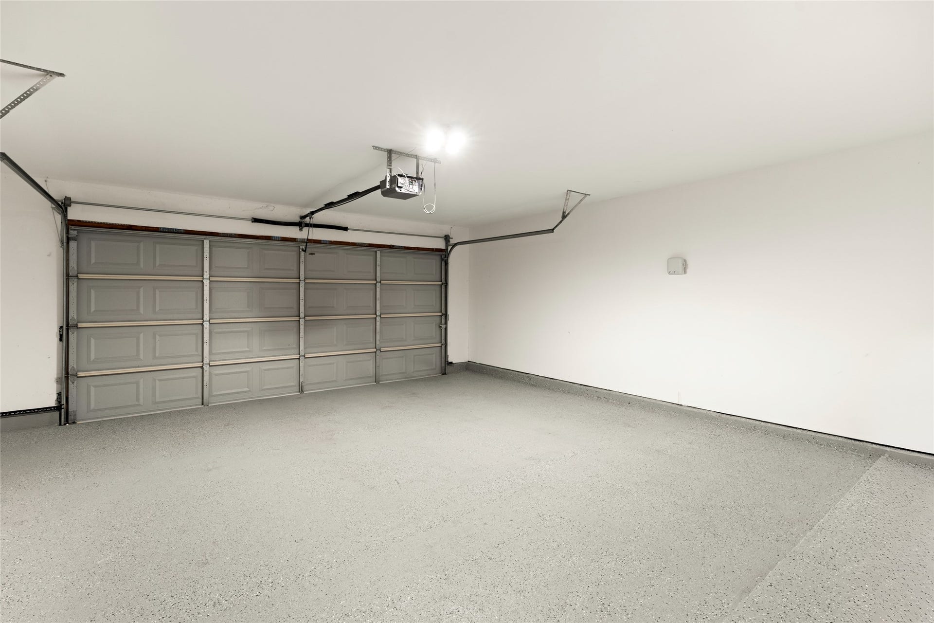 14 Lush Meadow Place, The Woodlands, TX 77381 Spacious garage with finished flooring and room for additional storage.