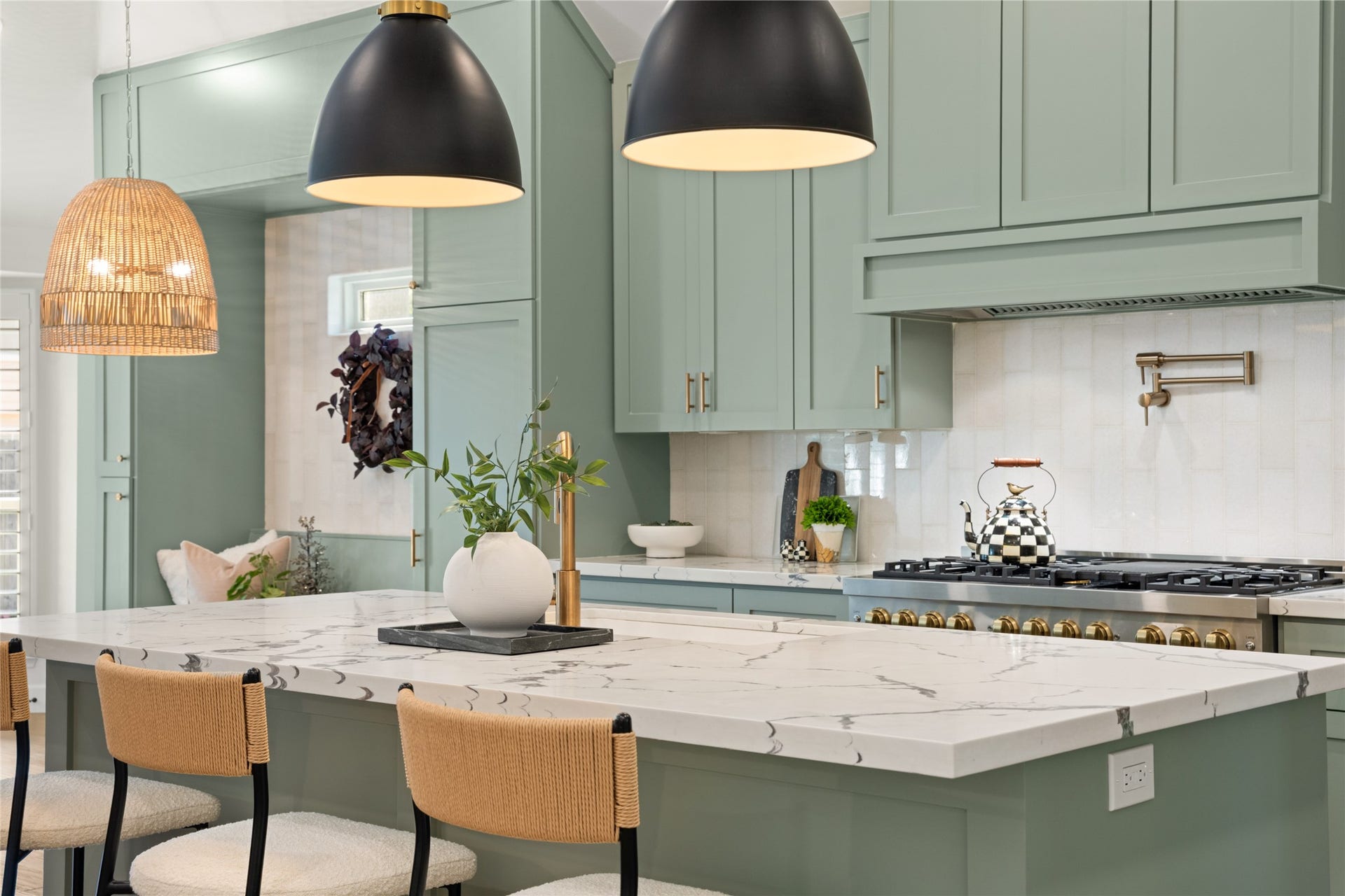 14 Lush Meadow Place, The Woodlands, TX 77381 Now THIS is a kitchen worth falling in love with! Gorgeous sage-green cabinetry, stunning gold accents, a professional-style gas range, and a showstopping island create a space that's as beautiful as it is functional!